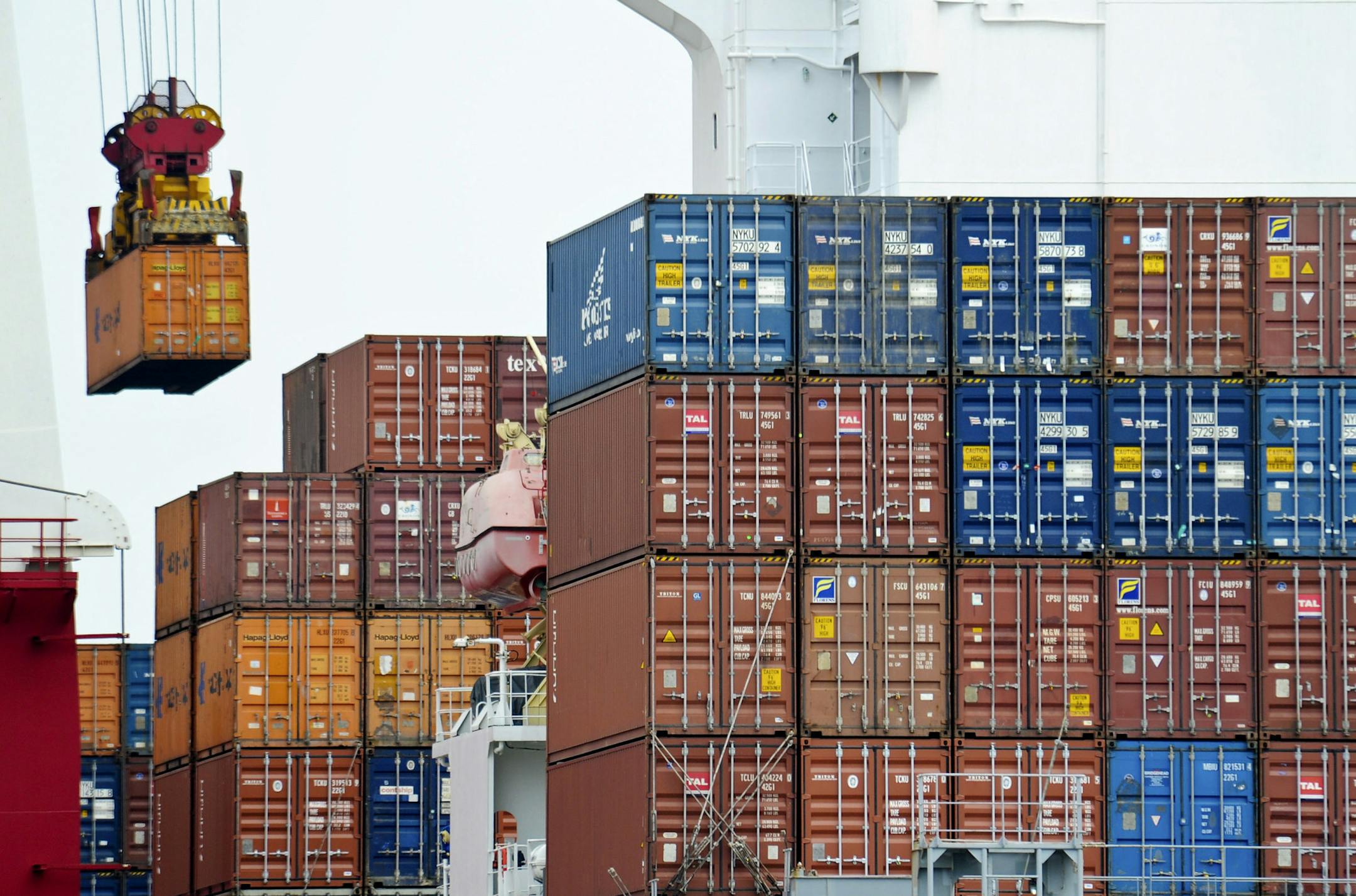FILE- In this Aug. 5, 2010, file photo, a container is loaded onto a cargo ship at the Tianjin port in China. American consumers and businesses would pay, literally, if President-elect Donald Trump follows through on his campaign pledge to slap big taxes on imports from China and Mexico. (AP Photo/Andy Wong, File)