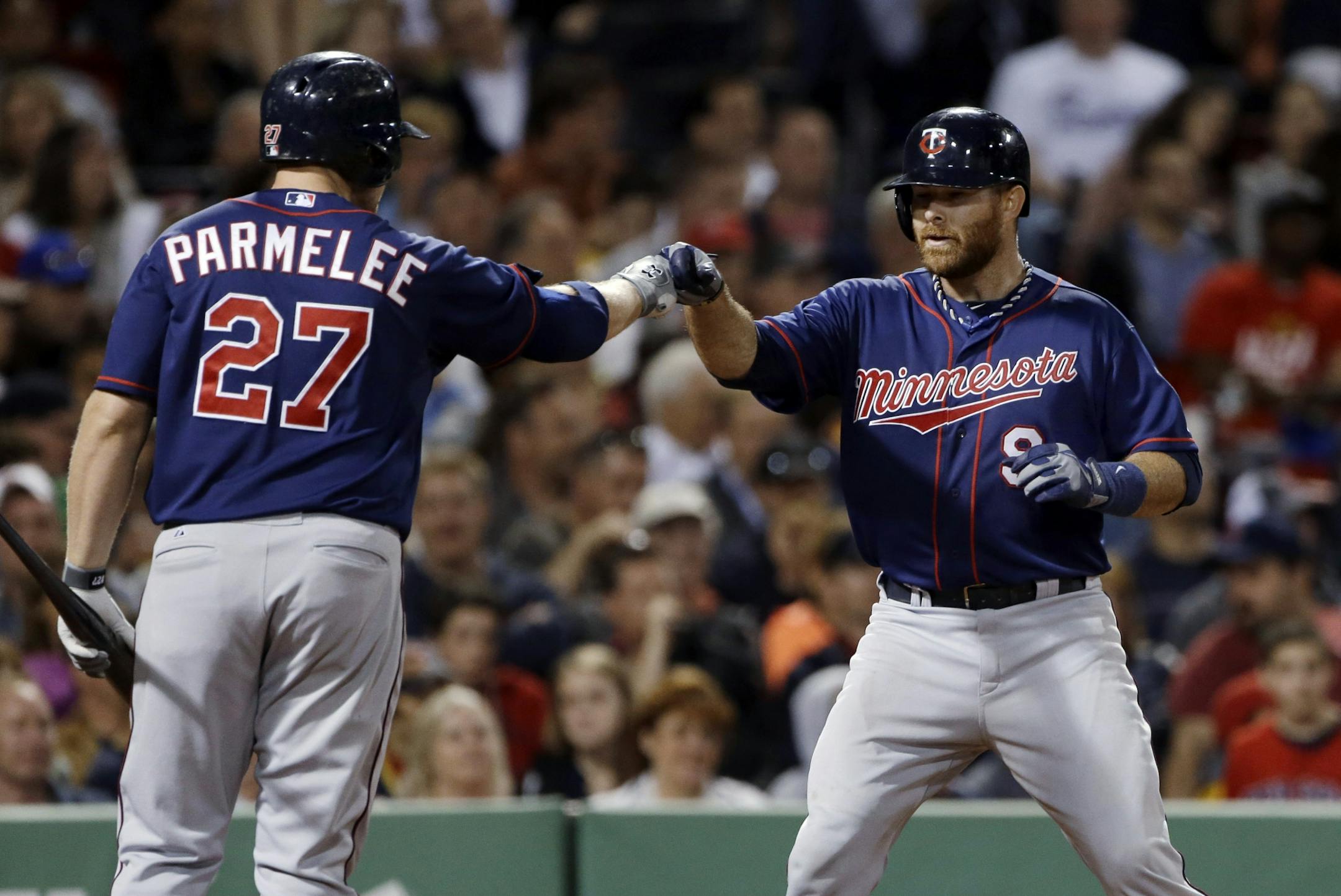 Twins designated hitter Ryan Doumit (9) celebrated his solo home run with Chris Parmelee during the seventh inning of the Twins' 6-1 victory over the Boston Red Sox at Fenway Park on Tuesday.