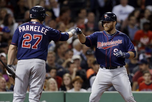 Twins designated hitter Ryan Doumit (9) celebrated his solo home run with Chris Parmelee during the seventh inning of the Twins' 6-1 victory over the 