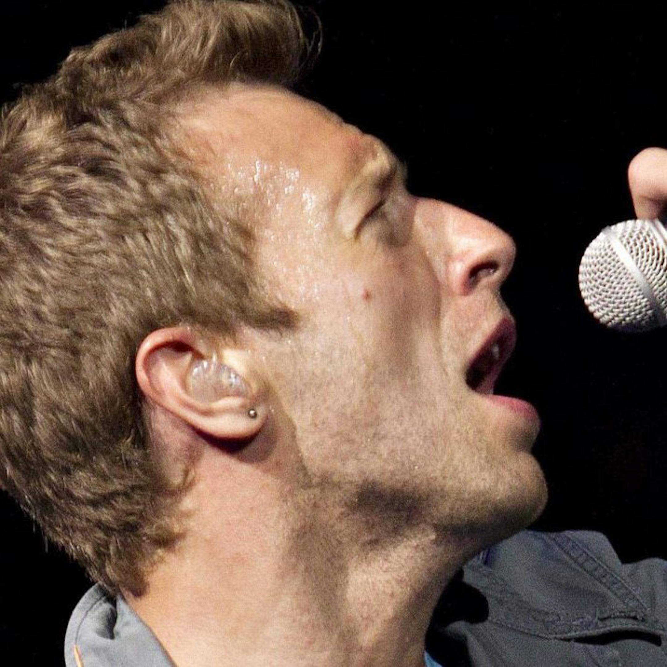 FILE - This April 17, 2012 file photo shows Chris Martin, lead singer of Coldplay, performing in Edmonton, Alberta, Canada. Coldplay will perform at the iTunes music festival during the South by Southwest festival in Austin, Texas. It will mark the U.S. debut of its popular iTunes Festival, a free concert series has been held for the past seven years in London. (AP Photo/The Canadian Press, Jason Franson, File)