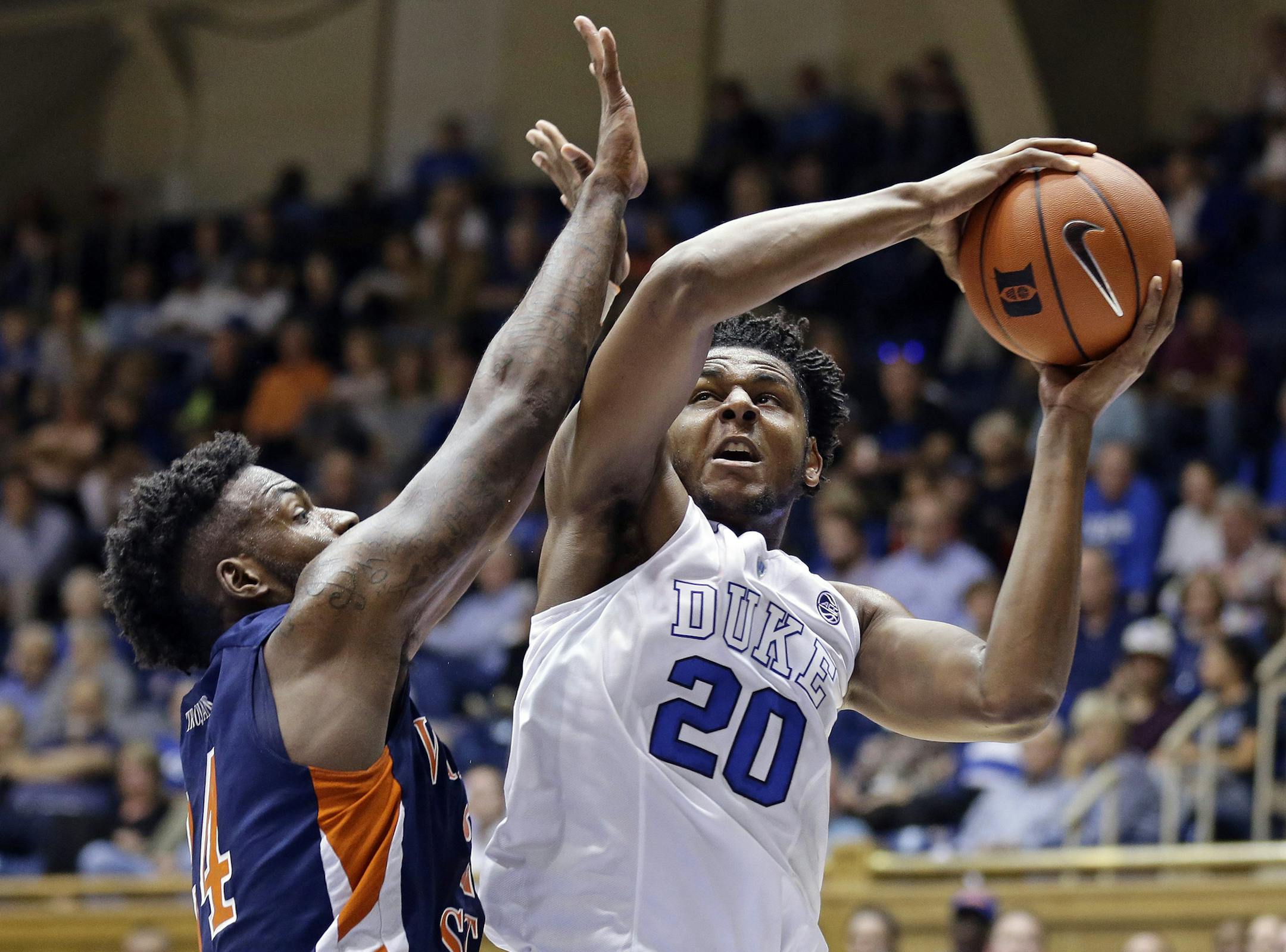 FILE - In this Oct. 28, 2016, file photo, Duke's Marques Bolden (20) is pressured by Virginia State's Amiel Terry during the first half of an exhibition NCAA college basketball game in Durham, N.C. Dukeís six-man freshman class has four of the nationís top 15 recruits according to composite rankings of recruiting websites compiled by 247Sports. That group includes forwards Harry Giles (No. 2) and Jayson Tatum (No. 4), guard Frank Jackson (No. 13) and center Marques Bolden (No. 15). (AP