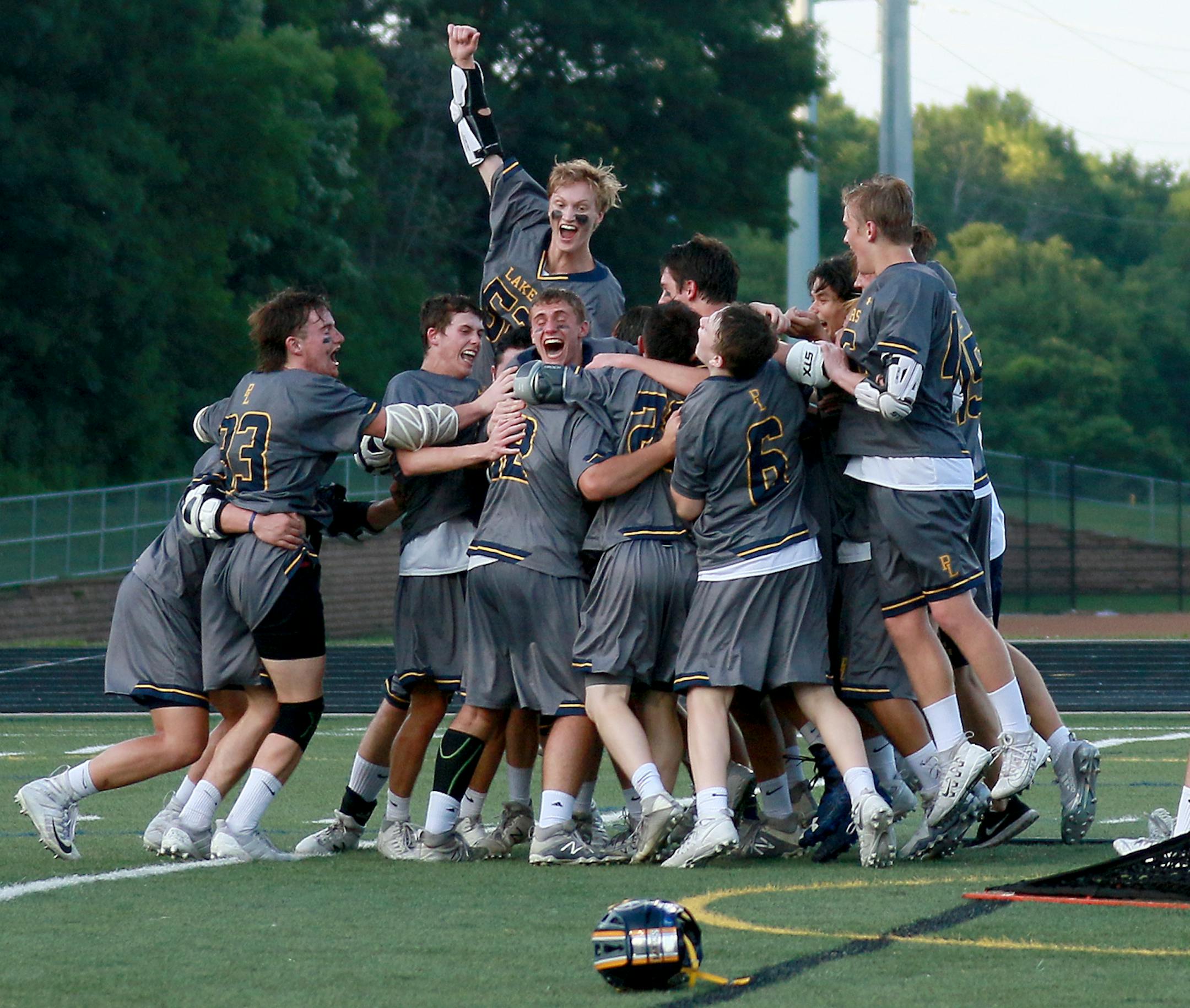 Prior Lake players celebrate after beating Benilde-St. Margaret's 10-8 during the Minnesota State High School League boys' lacrosse championship at Chanhassen High in Chanhassen, MN.] DAVID JOLES ï david.joles@startribune.com Prior Lake and Benilde-St. Margaret's during the first half of the Minnesota State High School League boys' lacrosse championship at Chanhassen High in Chanhassen, MN.