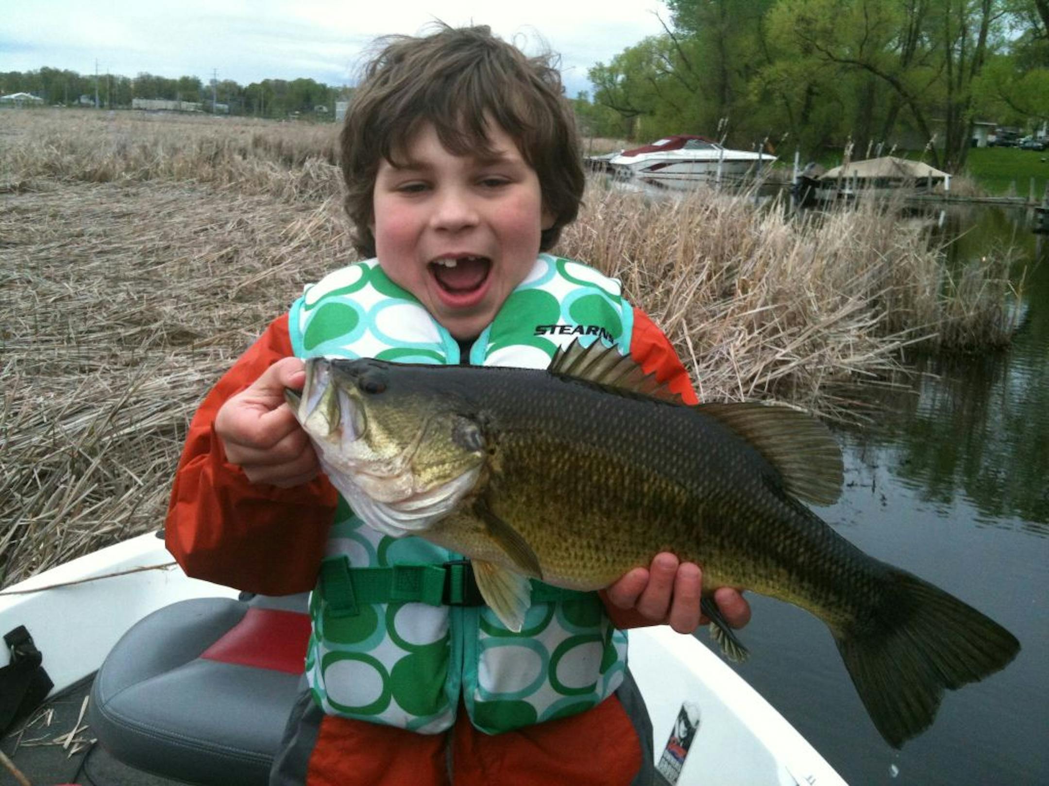 BASS BUSTER: Eight-year-old Evan Middag of Savage caught and released this nice largemouth bass on Lake Minnetonka while crappie fishing. "It would almost make it to the boat, then it would try to get away again, taking more line," Evan said. "Finally the fish made it into the boat because it got tired''