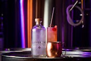 A Vodskey bottle beside a "Copper Mule," made with Vodskey, fresh lime juice and Fever Tree ginger beer, as well as a "Wing in a Sling," back, with Vo