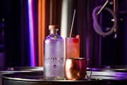 A Vodskey bottle beside a "Copper Mule," made with Vodskey, fresh lime juice and Fever Tree ginger beer, as well as a "Wing in a Sling," back, with Vo