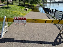 A flooded pathway in a St. Paul park is closed due to high water.