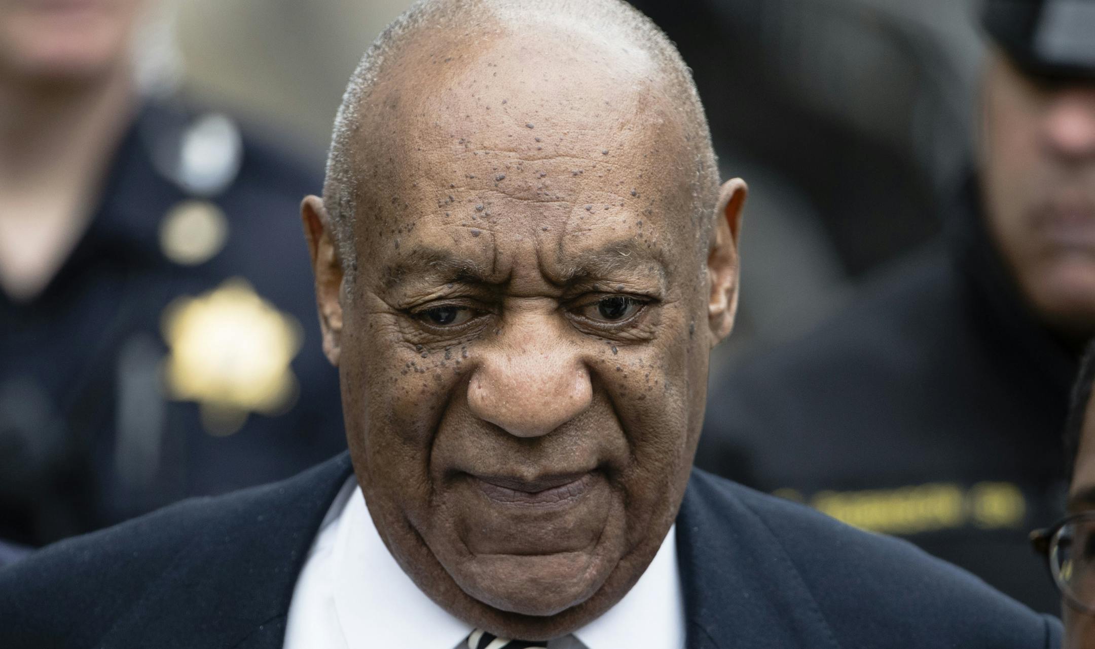 FILE - In this April 3, 2017, file photo, Bill Cosby departs after a pretrial hearing in his sexual assault case at the Montgomery County Courthouse in Norristown, Pa. Cosby says he doesn't expect to testify at his Pennsylvania sexual assault trial. spoke to Sirius radio host Michael Smerconish in an interview being broadcast Tuesday. Smerconish says he agreed to air an uncut, 82-minute conversation between Cosby and his daughters in exchange for the interview. (AP Photo/Matt Rourke, File)