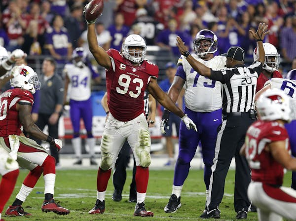 Arizona Cardinals defensive end Calais Campbell (93) holds up the football after a fumble recovery for the win against the Minnesota Vikings during th