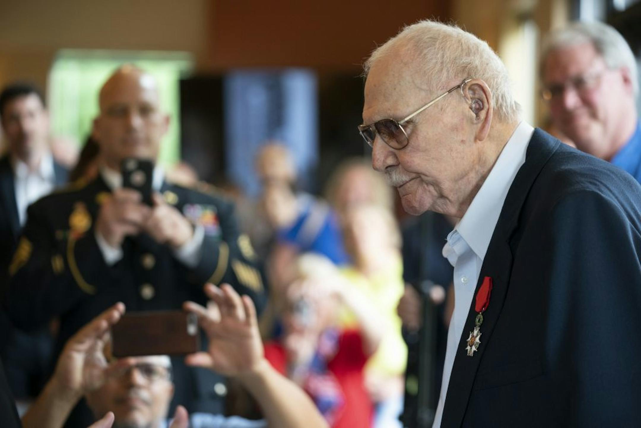The room applauded after Guillaume Lacroix, Consul General of France to the Midwest Region after he pinned the Legion of Honor medal on Boyd W. Sorenson's lapel Monday afternoon.