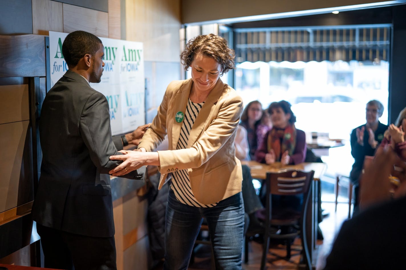 St Paul Mayor Melvin Carter and Duluth Mayor Emily Larson talked with voters at a Main Street coffee shop in Ames, Iowa, to stump for Senator Amy Klobuchar who is stuck in Washington, D.C. for the impeachment trial.