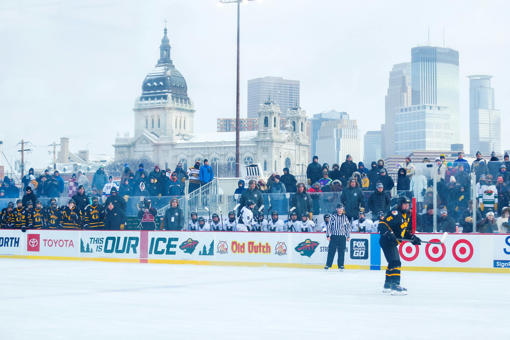 Against the backdrop of the Minneapolis skyline, players from Warroad and Minneapolis played their Hockey Day Minnesota game at Parade stadium. Warroad won the game 5-1. (Photo by Jeff Lawler, SportsEngine)