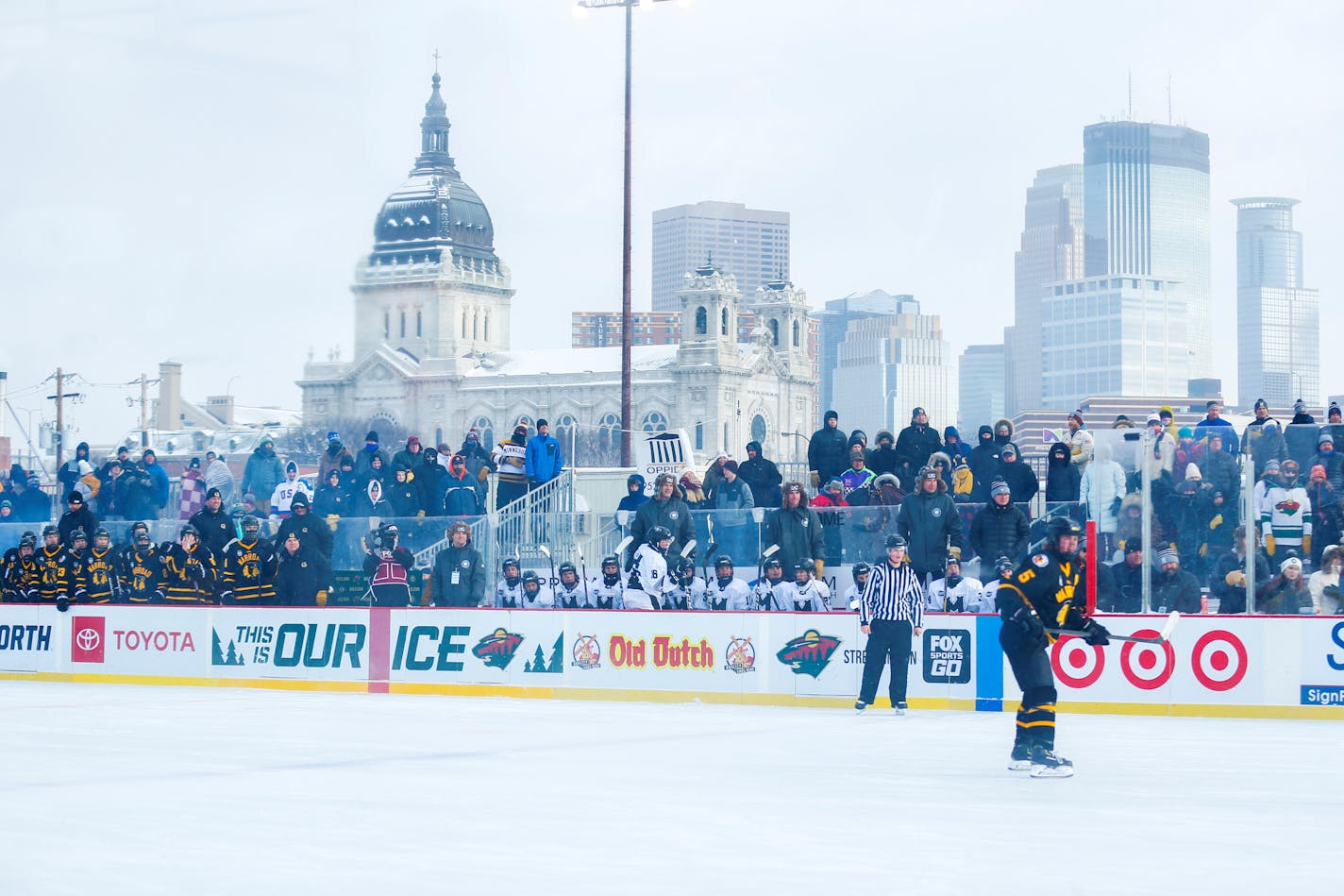 Against the backdrop of the Minneapolis skyline, players from Warroad and Minneapolis played their Hockey Day Minnesota game at Parade stadium. Warroad won the game 5-1. (Photo by Jeff Lawler, SportsEngine)