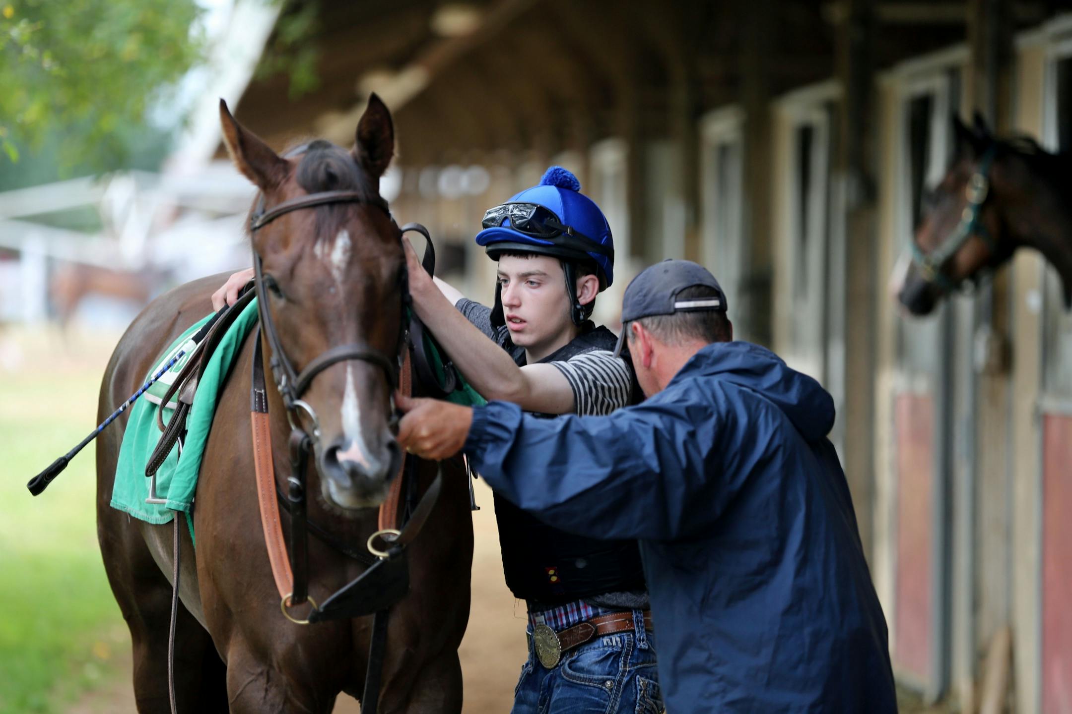 Young jockey Scott Bethke, 16, got ready to ride Little Tammy during a workout as his father, trainer Troy Bethke, looked on.