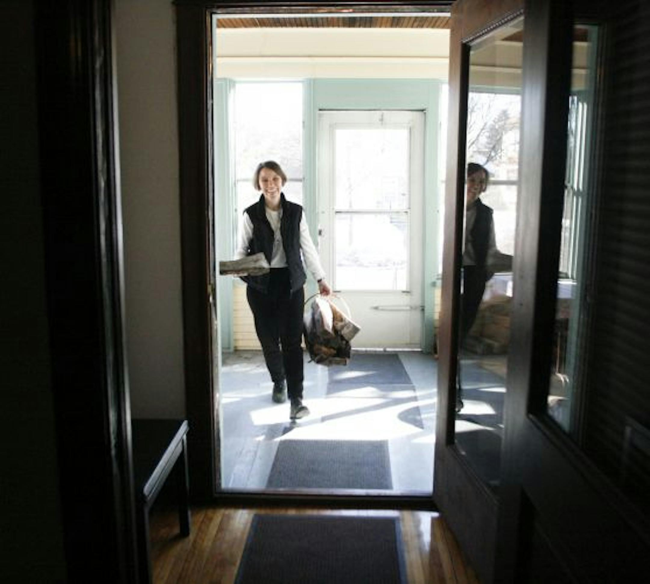 Sister Joanna O'Meara retrieved firewood from the porch in preparation for the evening prayer.