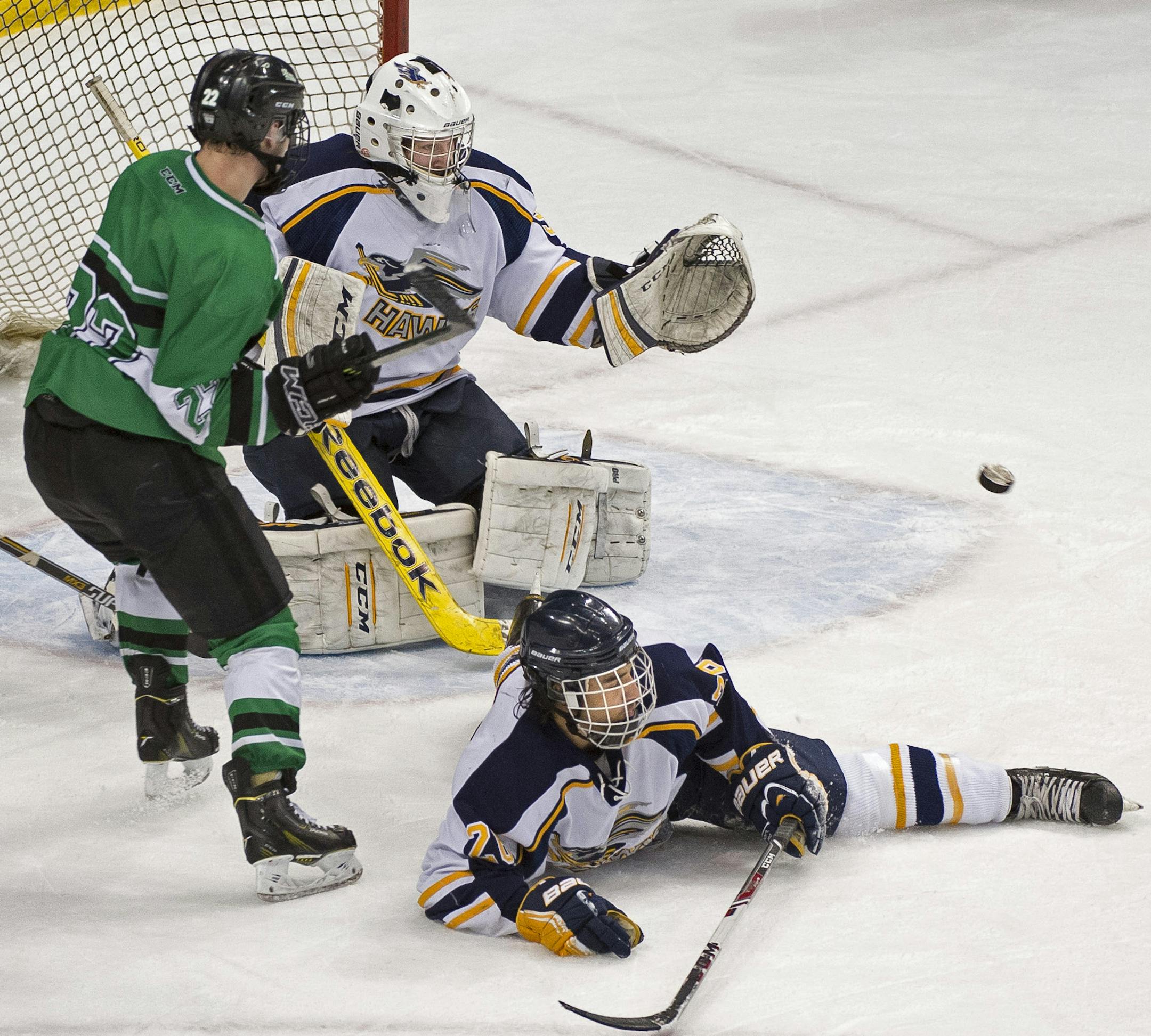A shot by East Grand Forks wing Tanner Tweten (19) was able to penetrate the defense of Hermantown goalie Luke Olson (32) for the game winning point in overtime. ] (Aaron Lavinsky | StarTribune) Hermantown plays East Grand Forks in the Class 1A boys' hockey state championship game on Saturday, March 7, 2015 at Xcel Energy Center. ORG XMIT: MIN1503071451011135