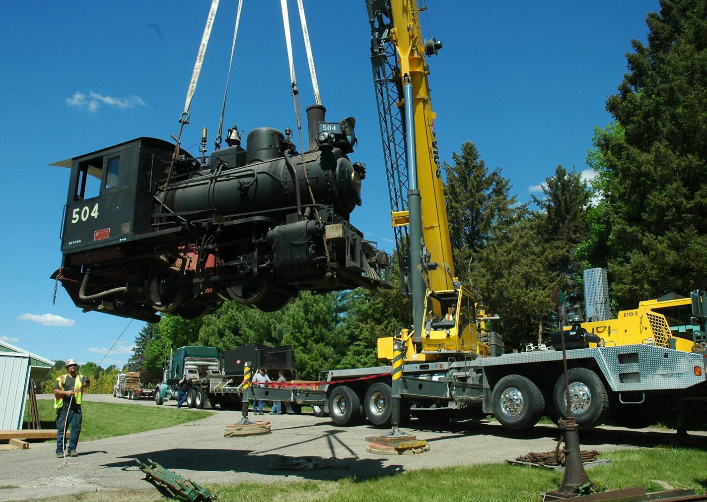 Workers lift the Czechoslovakian-built World War II steam engine owned by the estate of Jim Machacek onto a semi-trailer Wednesday, May 18, 2016, in Northfield, Minn. The estate sold the well-known Northfield train to Silver Dollar City, a theme park in Branson, Mo.