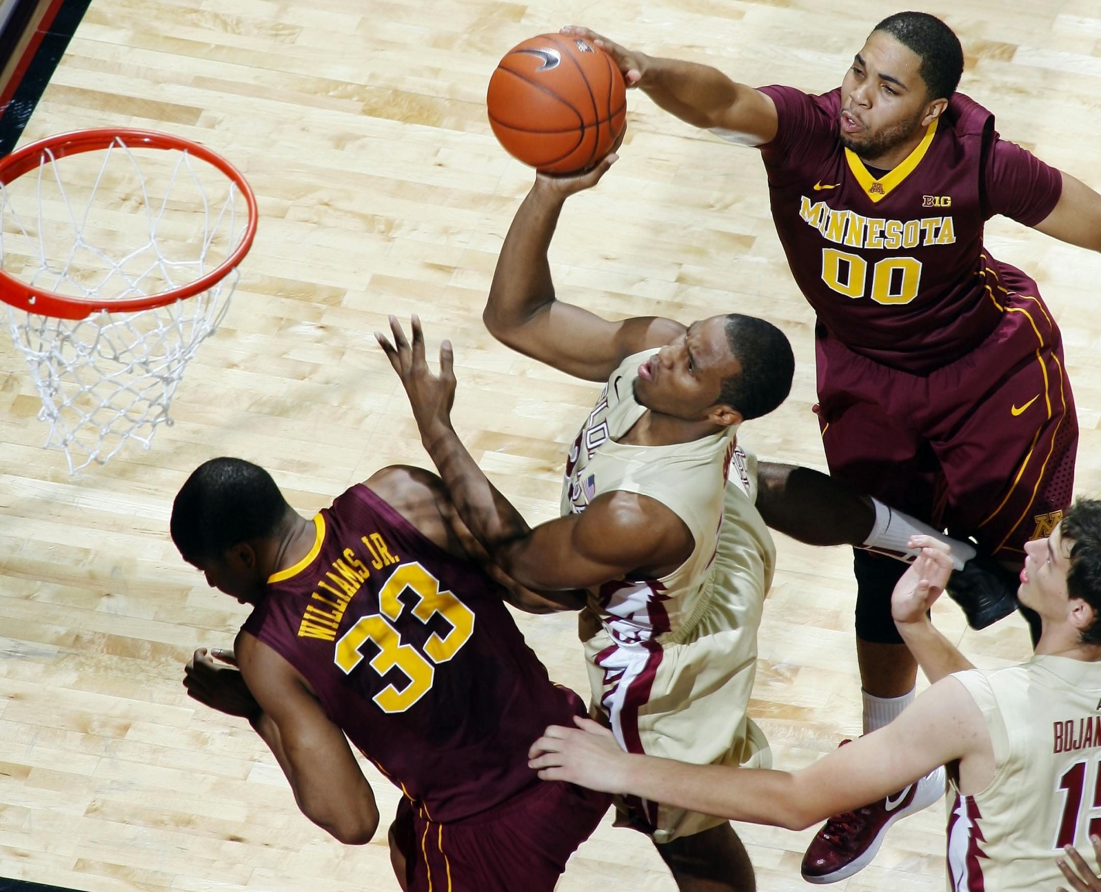 Rodney Williams Jr., fouls Florida State guard Michael Snaer Julian Welch tries to block the shot.