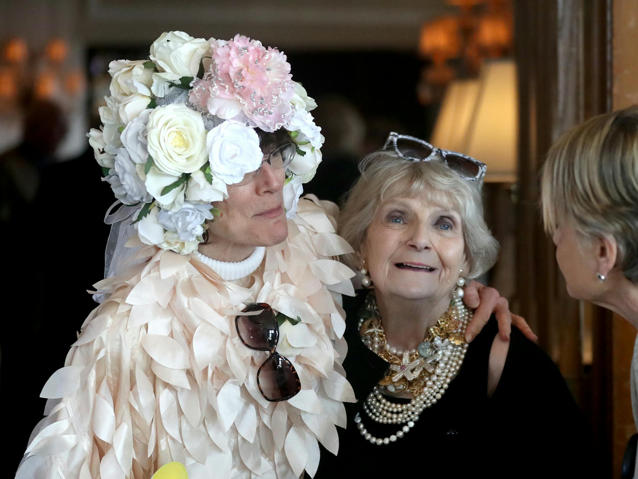 Barbara Carlson has been diagnosed with stage 4 cancer. Family and friends threw her a party Saturday, Feb. 10, 2018, at the University Club in St. Paul, MN. Here, Carlson is hugged by Jill Waterhouse in a flower costume she made for a past May Day. "It has nothing to do with me dying," Carlson said of the gathering. "It has everything to do with living."] DAVID JOLES ï david.joles@startribune.com Barbara Carlson has been diagnosed with stage 4 cancer. She's throwing herself a party Saturda