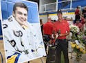 A cardboard cutout of Tiger Woods stood beside Mack Motzko's picture at his celebration of life ceremony Monday, Aug. 2, 2021 in St. Cloud. The family