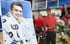A cardboard cutout of Tiger Woods stood beside Mack Motzko's picture at his celebration of life ceremony Monday, Aug. 2, 2021 in St. Cloud. The family