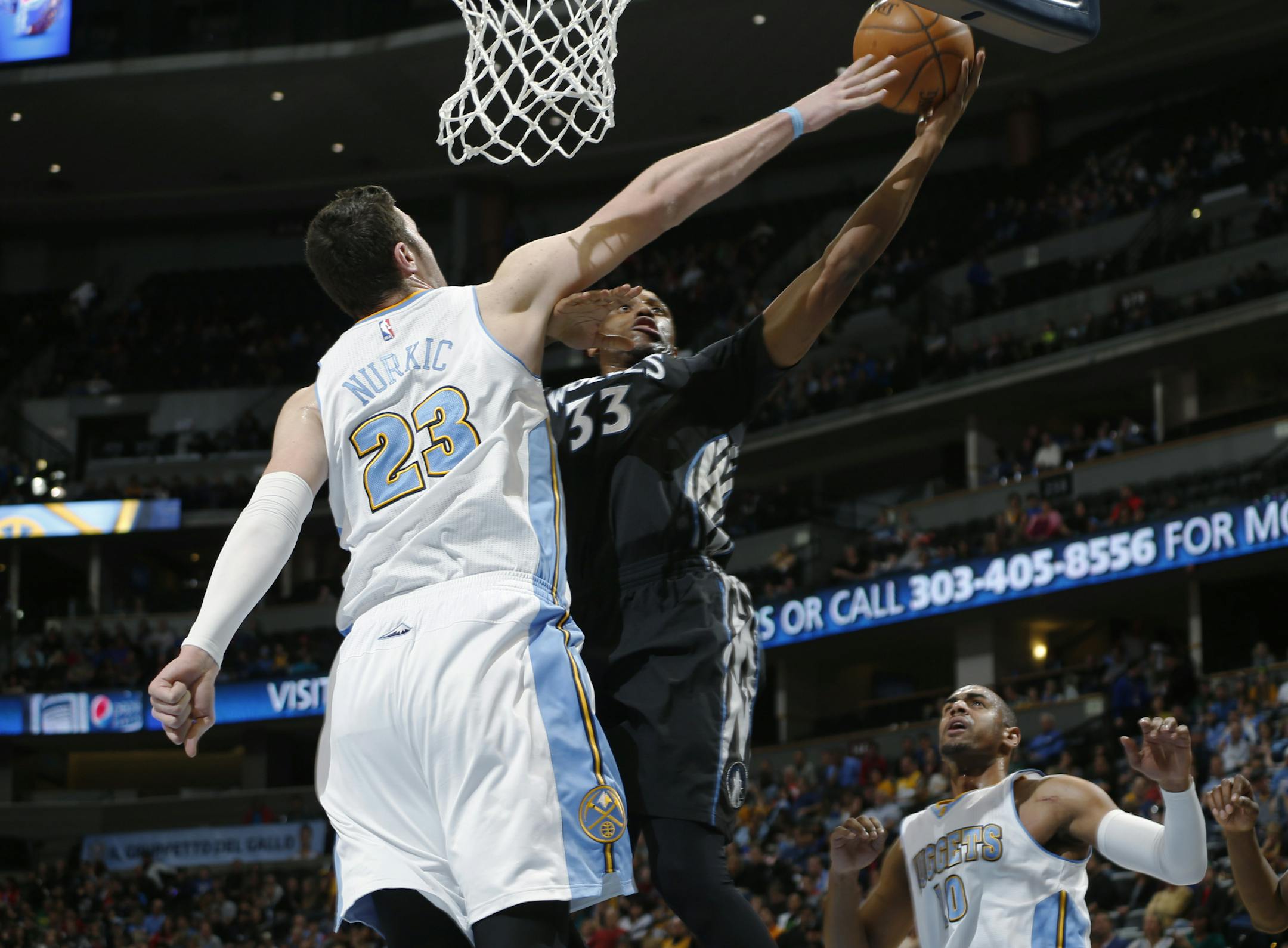 Denver Nuggets center Jusuf Nurkic, left, blocks a shot by Minnesota Timberwolves forward Thaddeus Young in the first quarter of an NBA basketball game Saturday, Jan. 17, 2015, in Denver. (AP Photo/David Zalubowski)