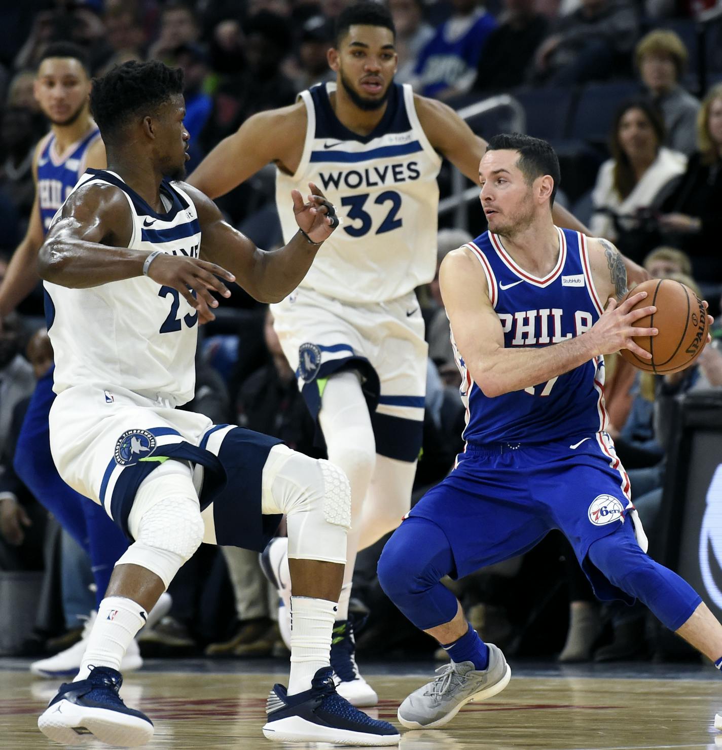 Minnesota Timberwolves guard Jimmy Butler (23) and center Karl-Anthony Towns (32) guard Philadelphia 76ers forward JJ Redick (17) during overtime of an NBA basketball game on Tuesday, Dec. 12, 2017, in Minneapolis. The 76ers won 118-112. (AP Photo/Hannah Foslien) ORG XMIT: MIN2018011921562544