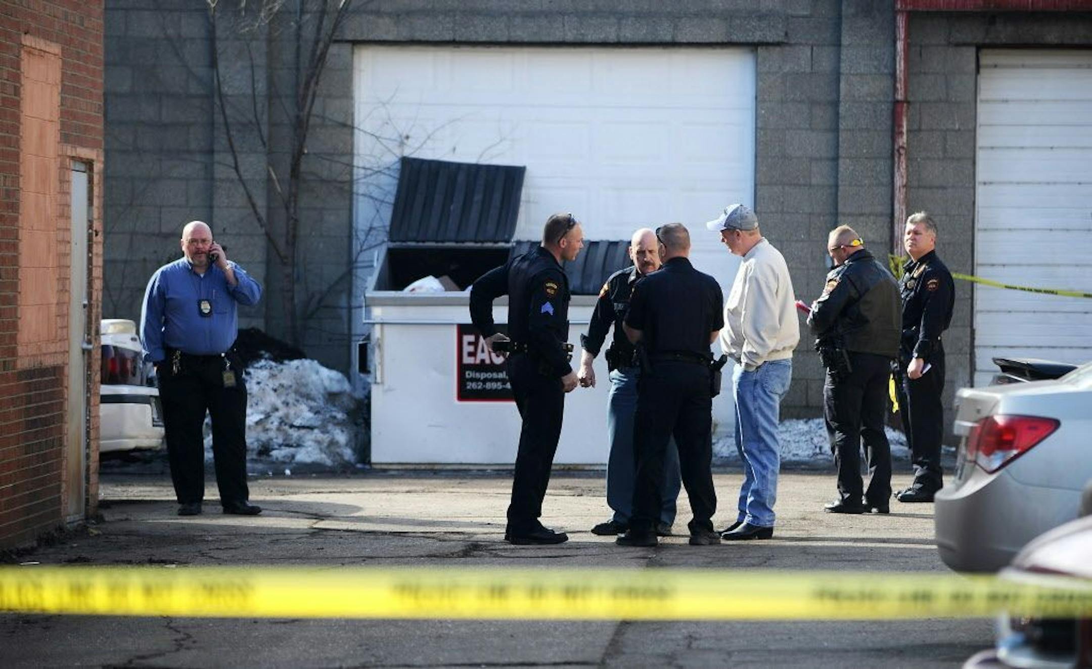 The Kenosha Police Department investigates a scene in Kenosha, Wis., on Saturday, March 14, 2015 after an officer shot and killed a suspect during a chase.