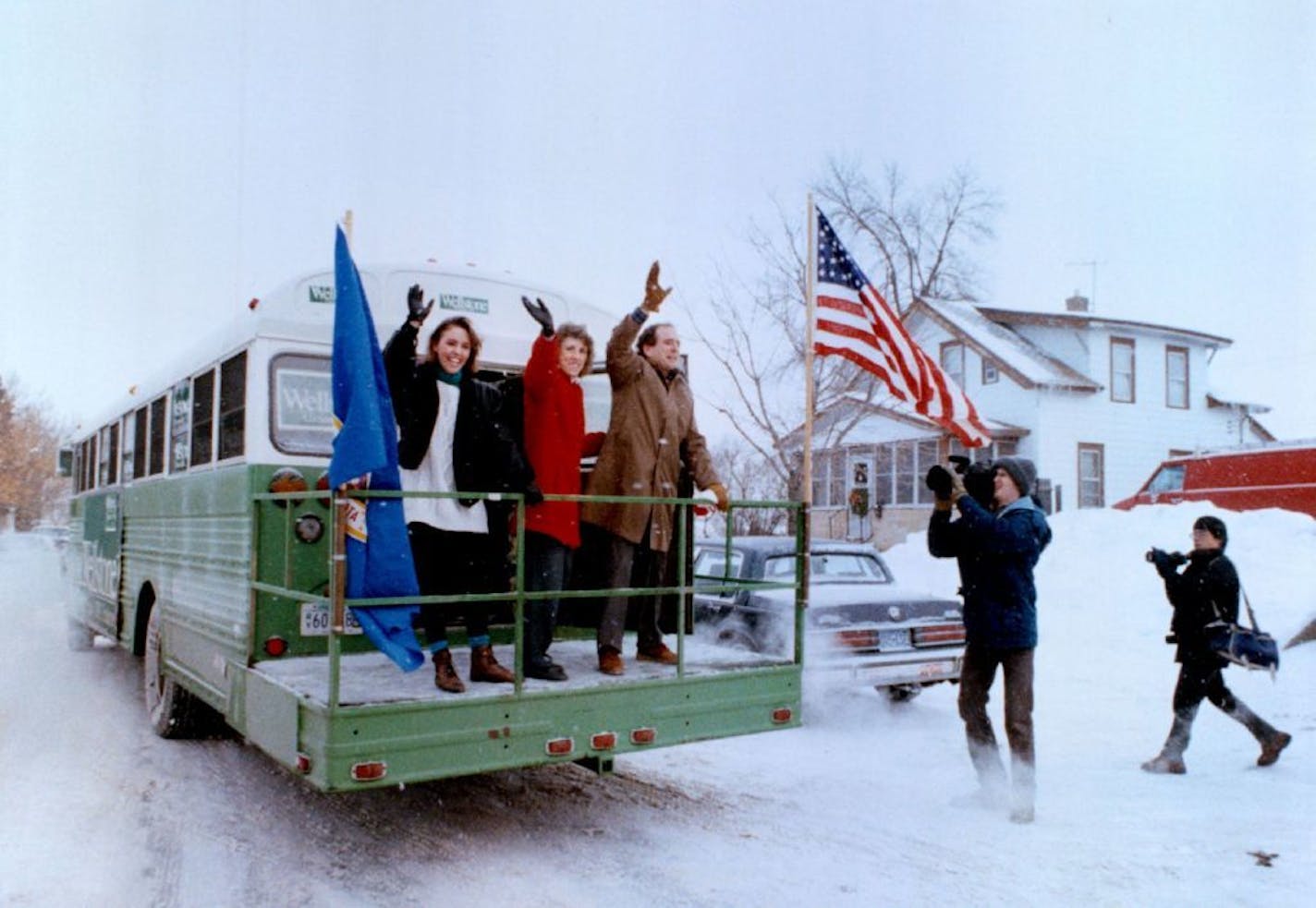 December 30, 1990 Washington or bust Sen.-elect Paul Wellstone, group with his daughter Marcia and wife, Shella, waved farewell from his bus Saturday before heading for Washington, D. C. The bus was used by Wellsotne in his campaign, and despite its rattletrap nature and yesterday's cold weather, it did well on the first leg of the trip. Joey McLeister, Minneapolis Star Tribune ORG XMIT: MIN2014062412242179