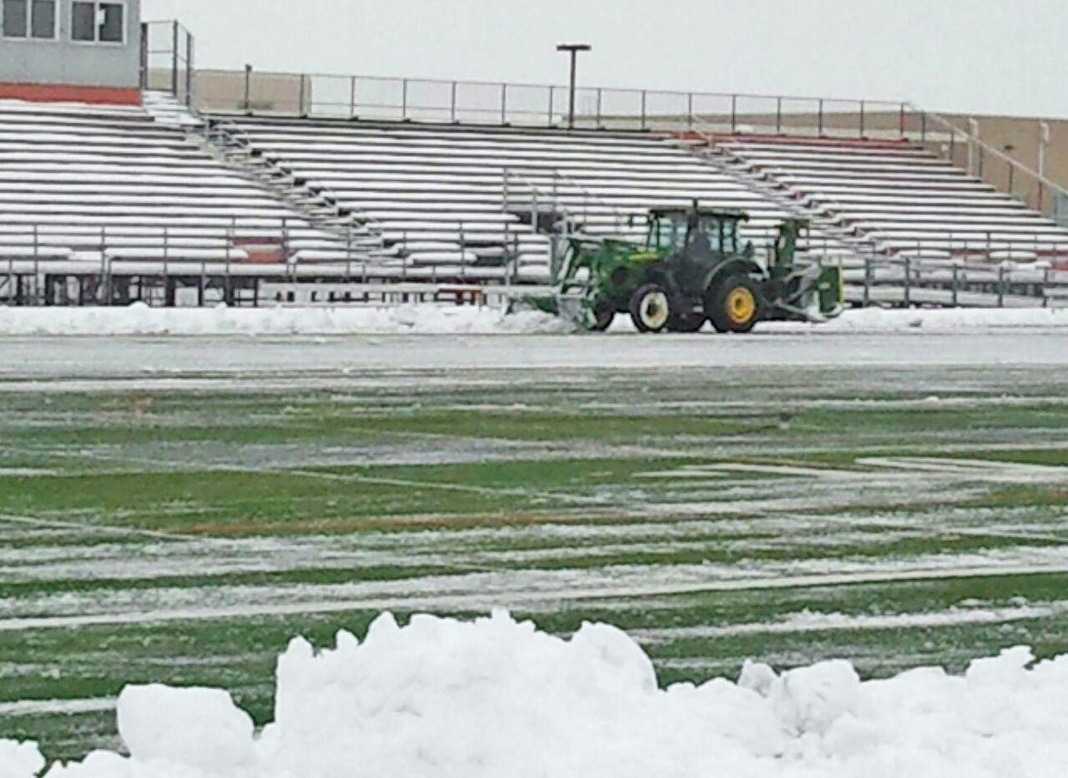 Crews spent Tuesday clearing snow from Osseo High School's football field, where Lakeville North and Totino-Grace are scheduled to play at 7 p.m. Thursday. The game between Class 6A schools is the first of 14 semifinal games that will be played through Saturday at five sites around the metro area as well as at St. Cloud State. Osseo also will host two games on Saturday. credit: Submitted photo 11/11/14