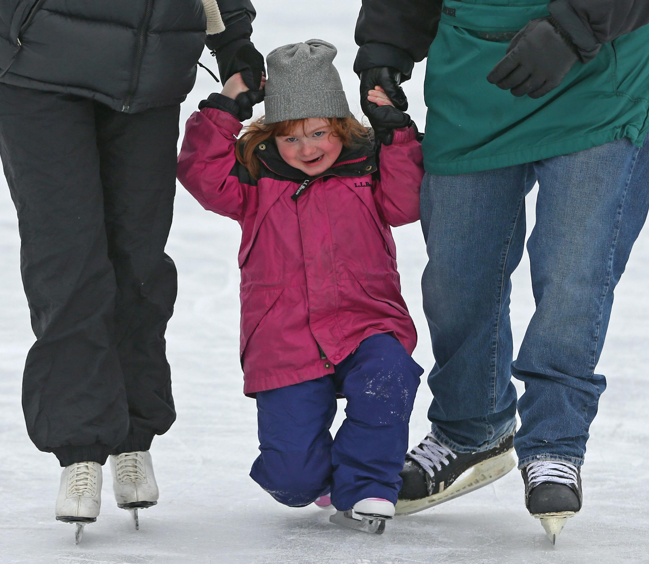 (left to right) Kathy Magill, Cece Magill-age 5 1/2 and John Magill, from Stillwater enjoyed the first day of skating at the Lake of the Isles skating rink, on 12/21/13. Saturday was the opening of the Minneapolis outdoor skating rinks. Over twenty rinks provided all types of skating opportunities including hockey, broomball and family open skating.] Bruce Bisping/Star Tribune bbisping@startribune.com Kathy Magill, Cece Magill, John Magill