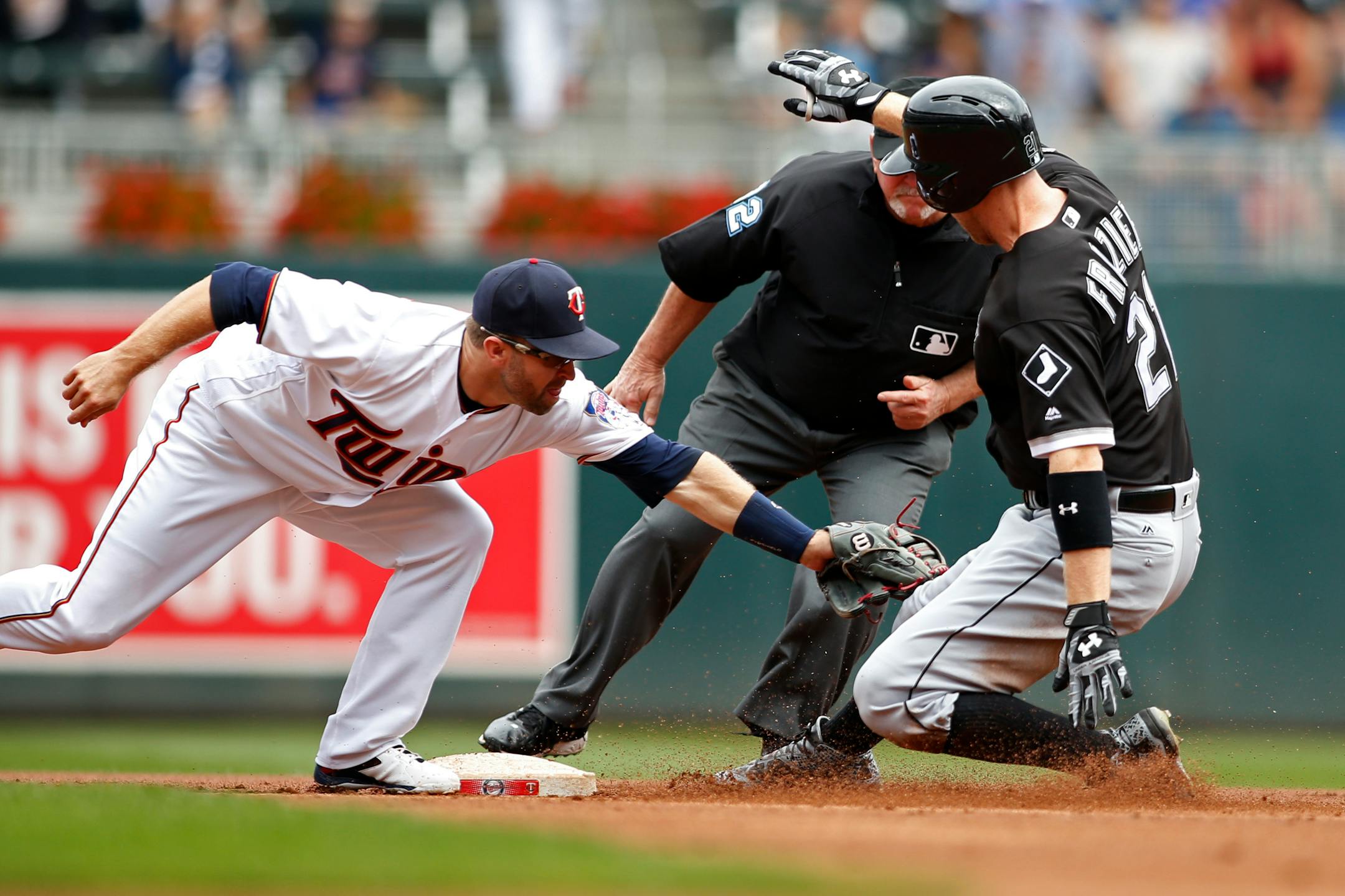 Twins second baseman Brian Dozier tagged out the White Sox's Todd Frazier trying to extend a single into a double in the first inning Sunday at Target Field.