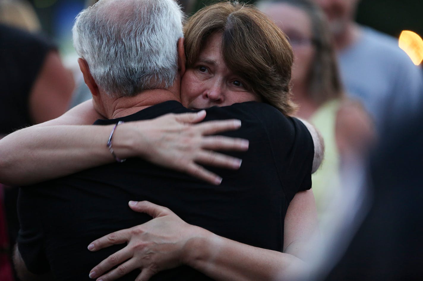 Michelle Patrick was hugged by many people as she attended a press conference at the scene of the shooting of her husband Mendota Heights Officer Scott Patrick in West St. Paul, Minn., on Friday August 1, 2014.