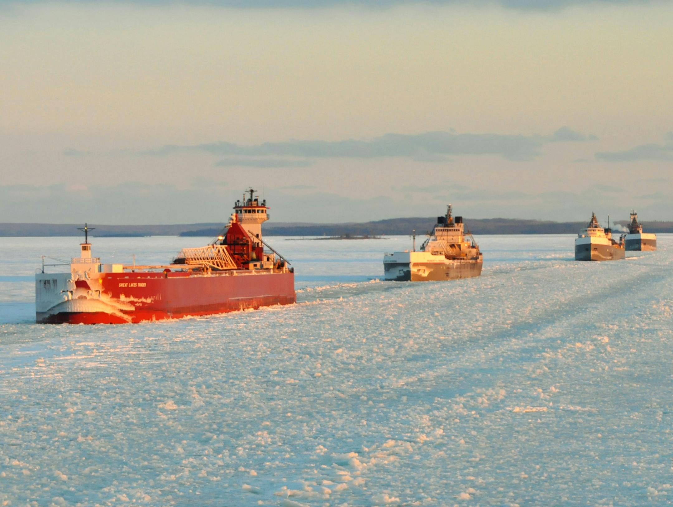 In this Jan. 9, 2014 photo provided by the U.S. Coast Guard a convoy of Great Lakes cargo ships line up to follow an icebreaker on the St. Marys River, which links Lakes Superior and Huron. As of Feb. 13, 88 percent of the Great Lakes surface was frozen, according to the federal government&#xed;s Great Lakes Environmental Research Laboratory in Ann Arbor. (AP Photo/Lt. David Lieberman)