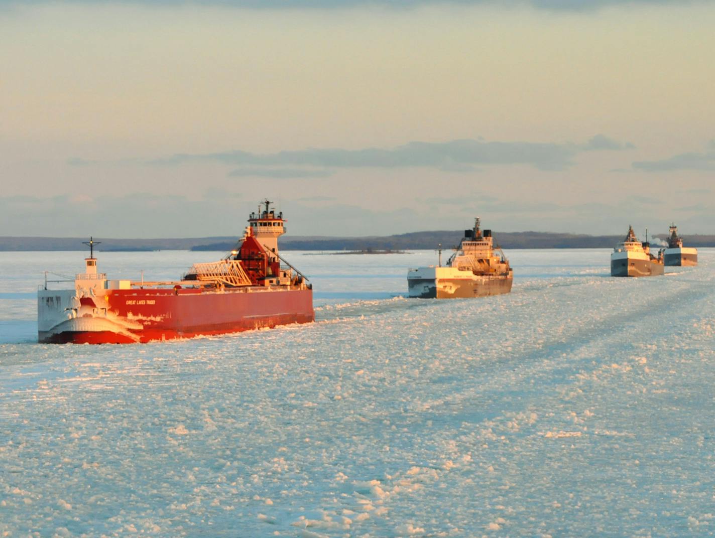 In this Jan. 9, 2014 photo provided by the U.S. Coast Guard a convoy of Great Lakes cargo ships line up to follow an icebreaker on the St. Marys River, which links Lakes Superior and Huron. As of Feb. 13, 88 percent of the Great Lakes surface was frozen, according to the federal government&#xed;s Great Lakes Environmental Research Laboratory in Ann Arbor. (AP Photo/Lt. David Lieberman)