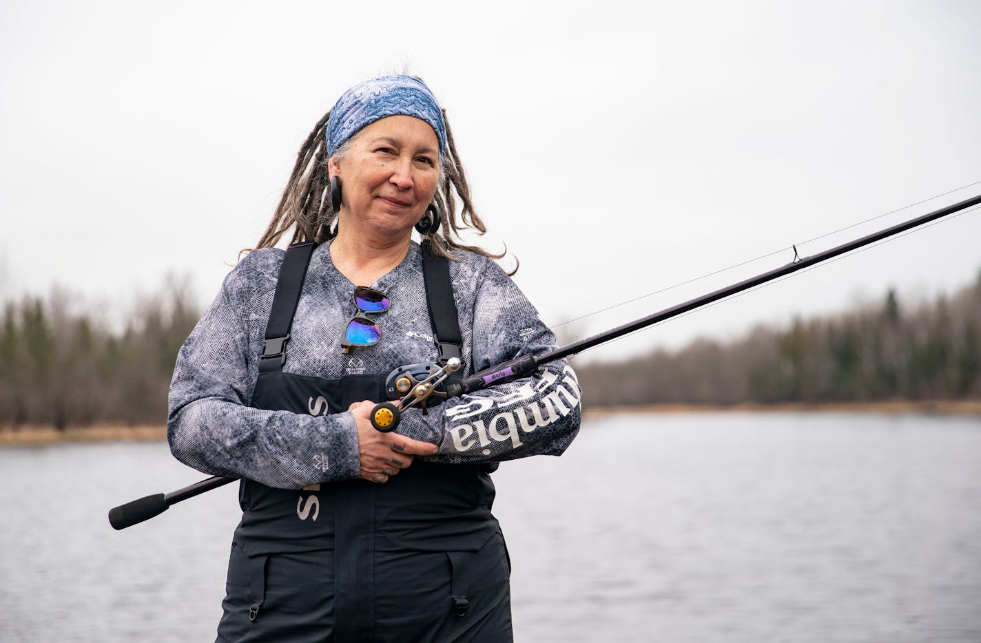 Karen McTavish posed for a portrait with one of her musky rods on the St. Louis River in Saginaw, Minn. on Tuesday. ]