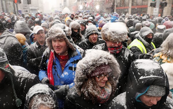 Super Bowl Live attendees made their way down Nicollet Mall after Levi LaValle leapt a snowmobile over the street for the Polaris UpsideDown stunt Sat