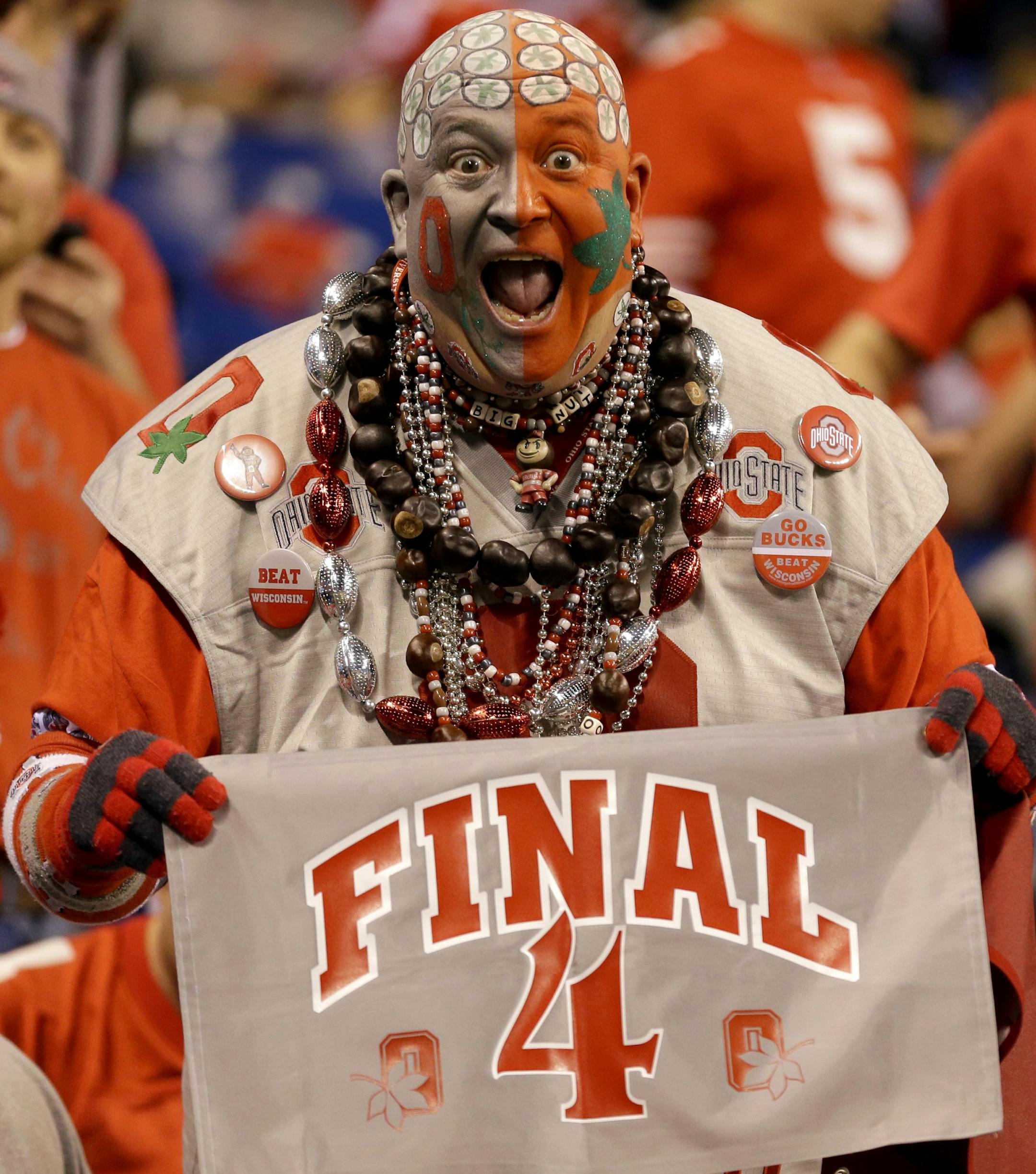 An Ohio State fan yells in the stands before the start of the Big Ten Conference championship NCAA college football game between Ohio State and Wisconsin Saturday, Dec. 6, 2014, in Indianapolis. (AP Photo/Michael Conroy)