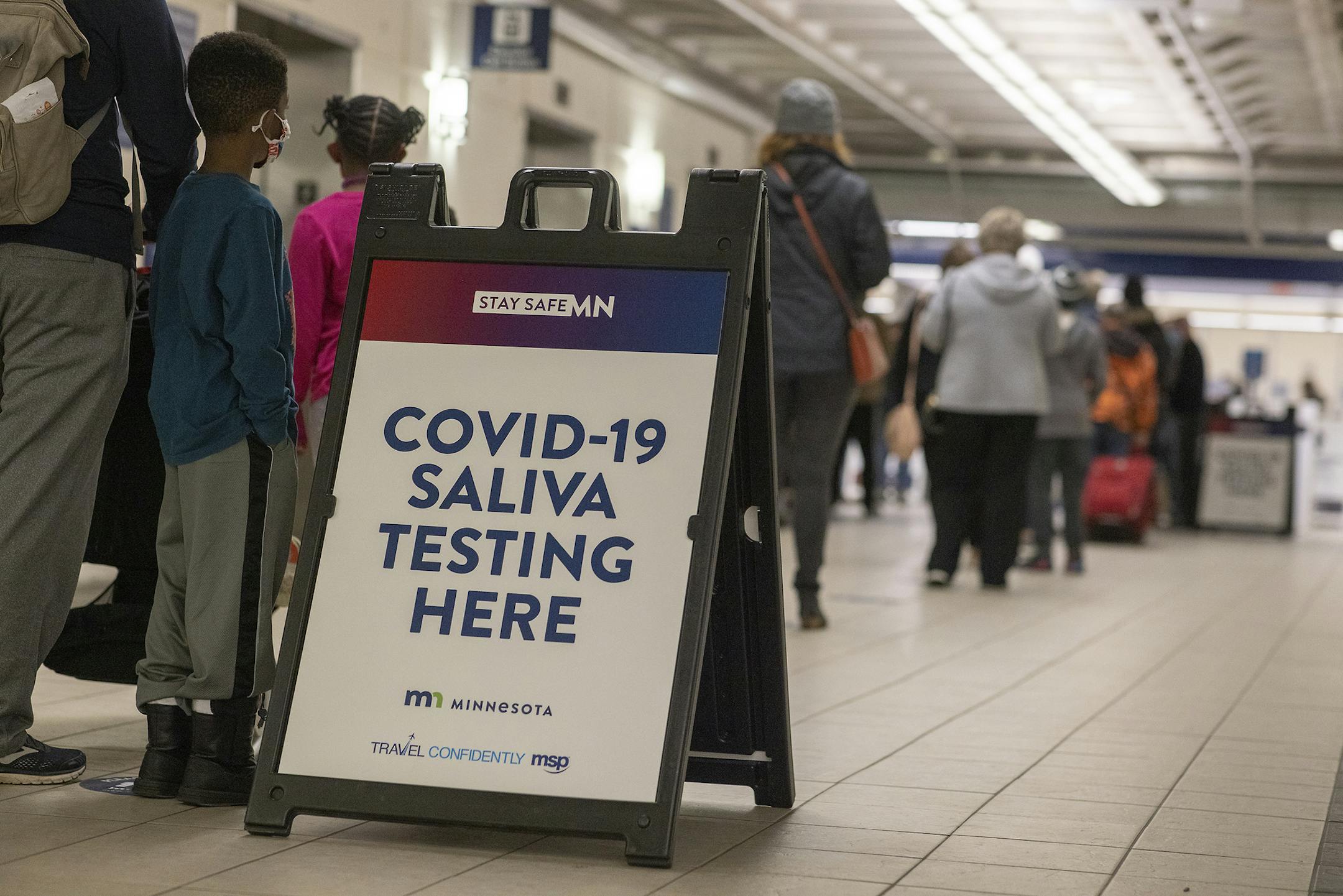 People stood in line to make their way through the new saliva COVID-19 testing site at the Minneapolis-St. Paul International Airport, Thursday, November 12, 2020.