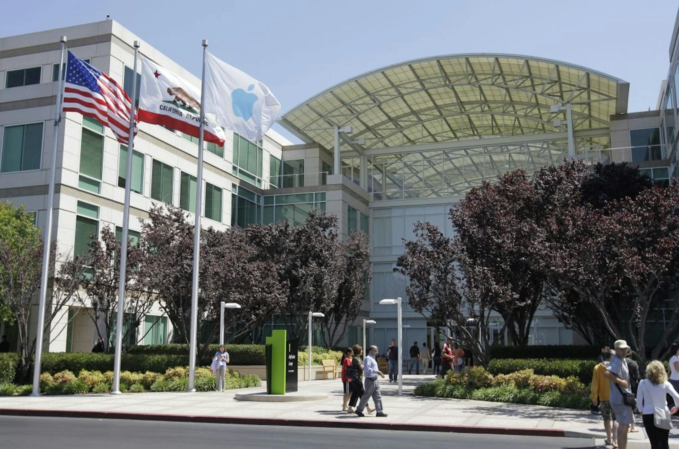 People walk by the Apple headquarters in Cupertino, Calif., Monday, Aug. 20, 2012. On Monday, Aug. 20, 2012, Apple set a new record for the most valuable company at $621 billion, beating Microsoft's 1999 high.