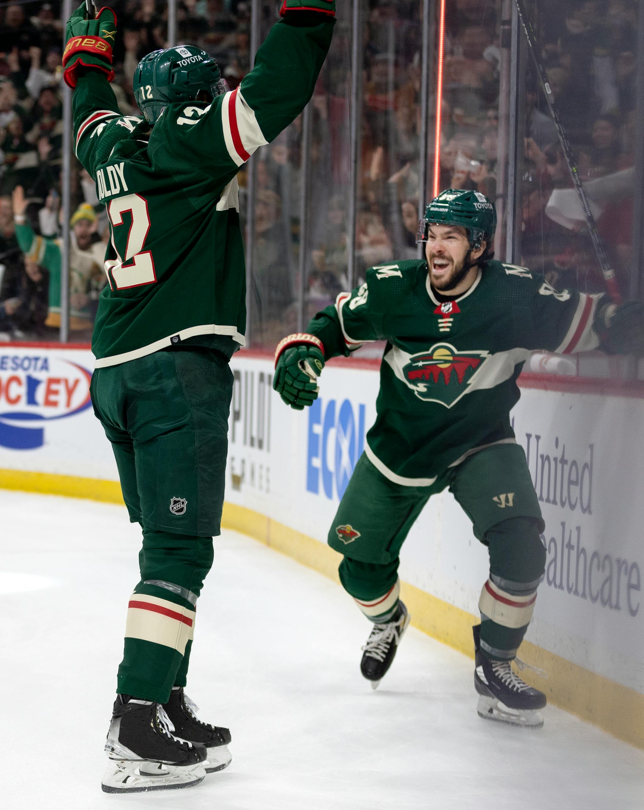 Matt Boldy (12) and Frederick Gaudreau (89) of the Minnesota Wild celebrate a Boldy goal in the first period.