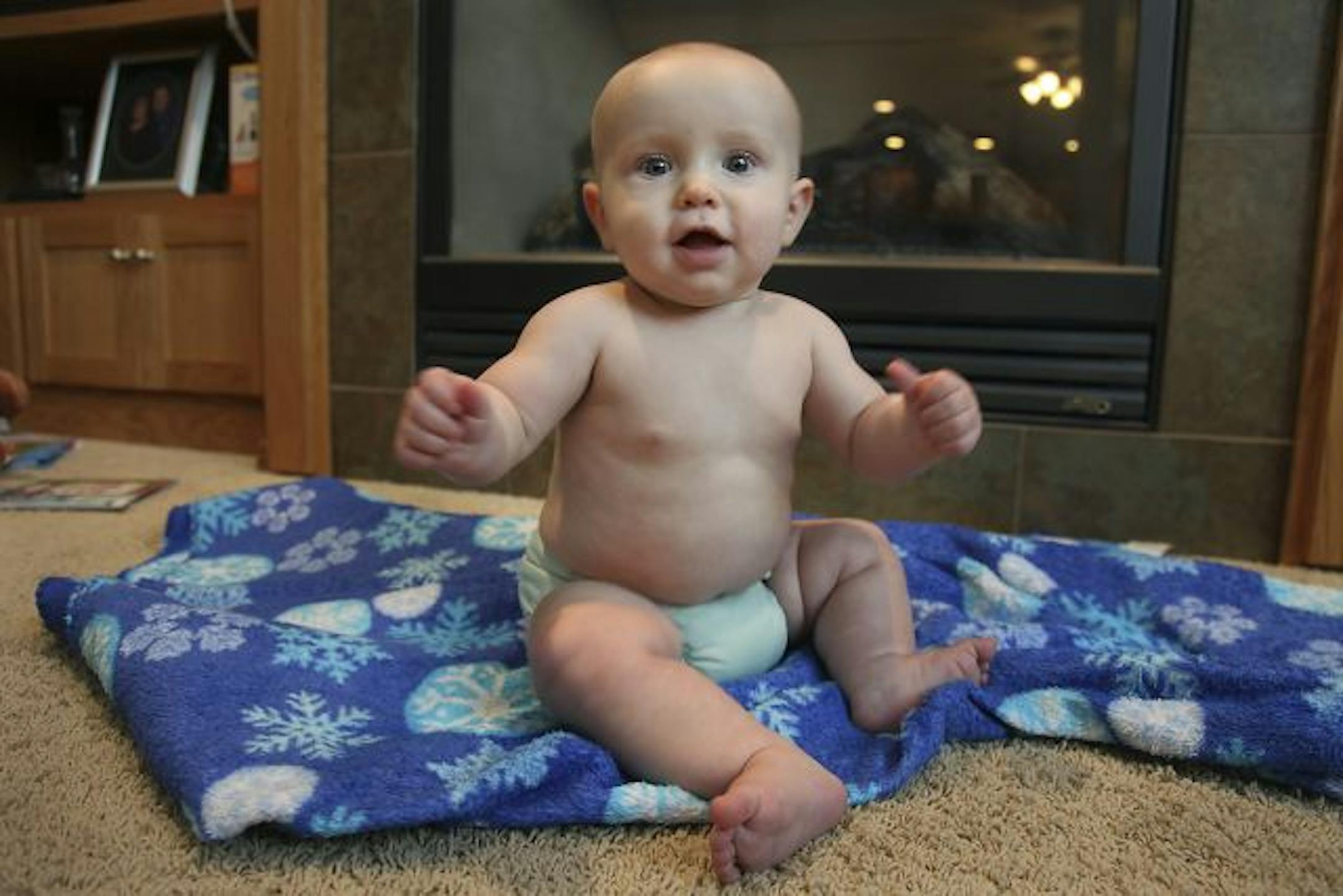 Eight-month-old Logan Schneider of Brooklyn Park wears reusable cloth diapers delivered weekly by a service.