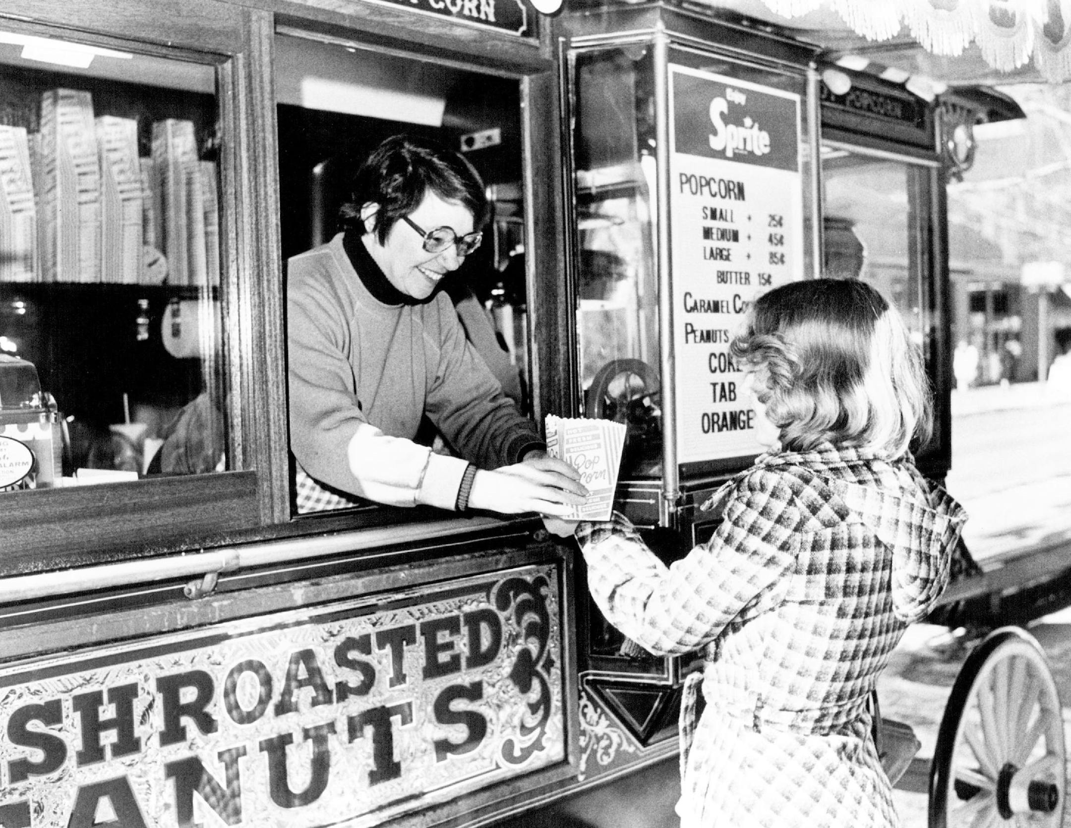 March 8, 1978 Sure Sign of Spring -- A noontime customer bought a bag of popcorn at Charlott's Popcorn Wagon as the "Popcorn Lady," Charlotte E. Sunderlin, opened her 1978 selling season on the Nicollet Mall Yesterday. The Wagon is located between 6th and 7th Streets. March 7, 1978 Jack Gillis, Minneapolis Star Tribune