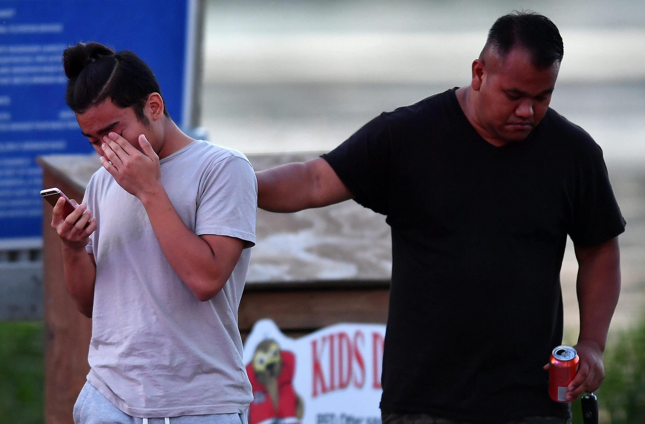 Two men were overcome with emotion at Maxwell Bay Launch at Lake Minnetonka as Hennepin County Sheriffs searched the water after a report of a drowning Saturday night.