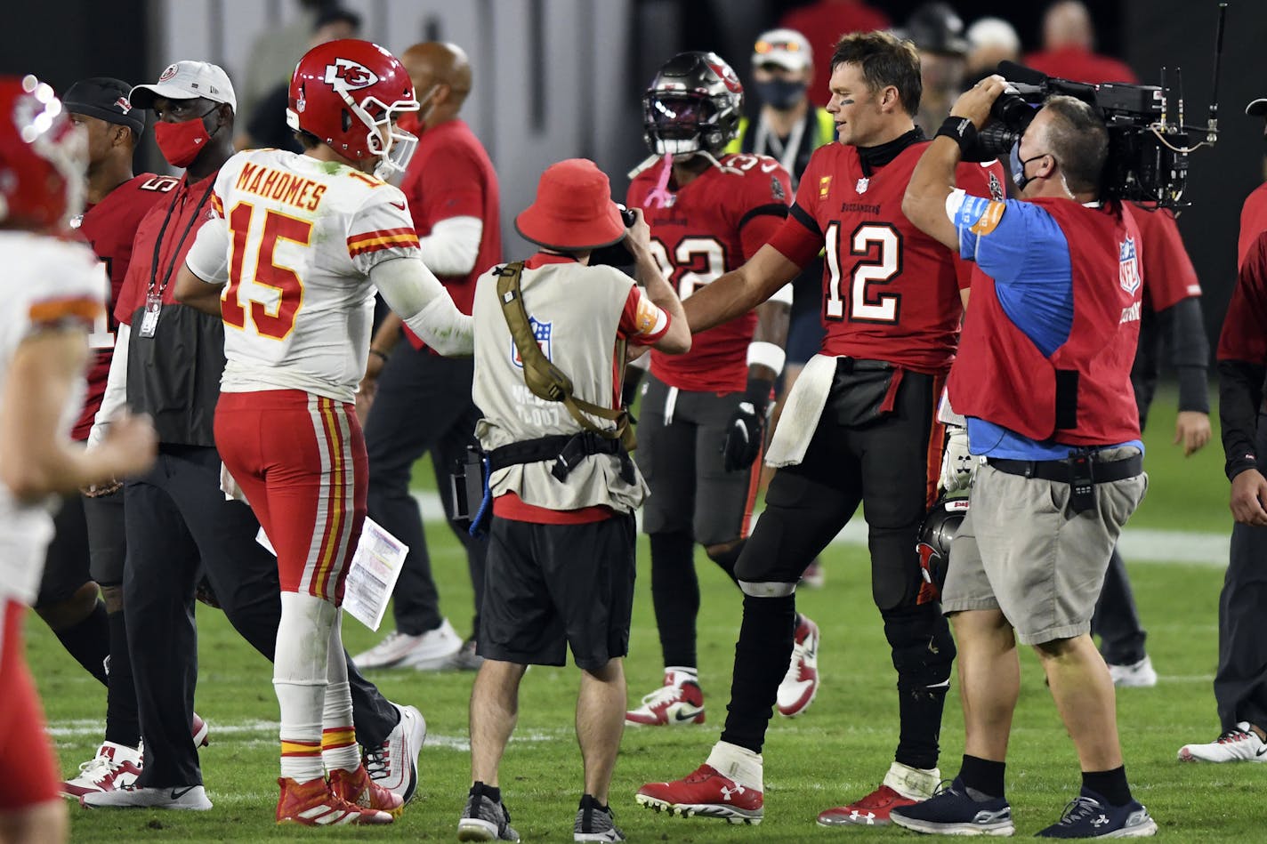 Tampa Bay Buccaneers quarterback Tom Brady (12) congratulates Kansas City Chiefs quarterback Patrick Mahomes (15) after their NFL football game Sunday, Nov. 29, 2020, in Tampa, Fla. (AP Photo/Jason Behnken)