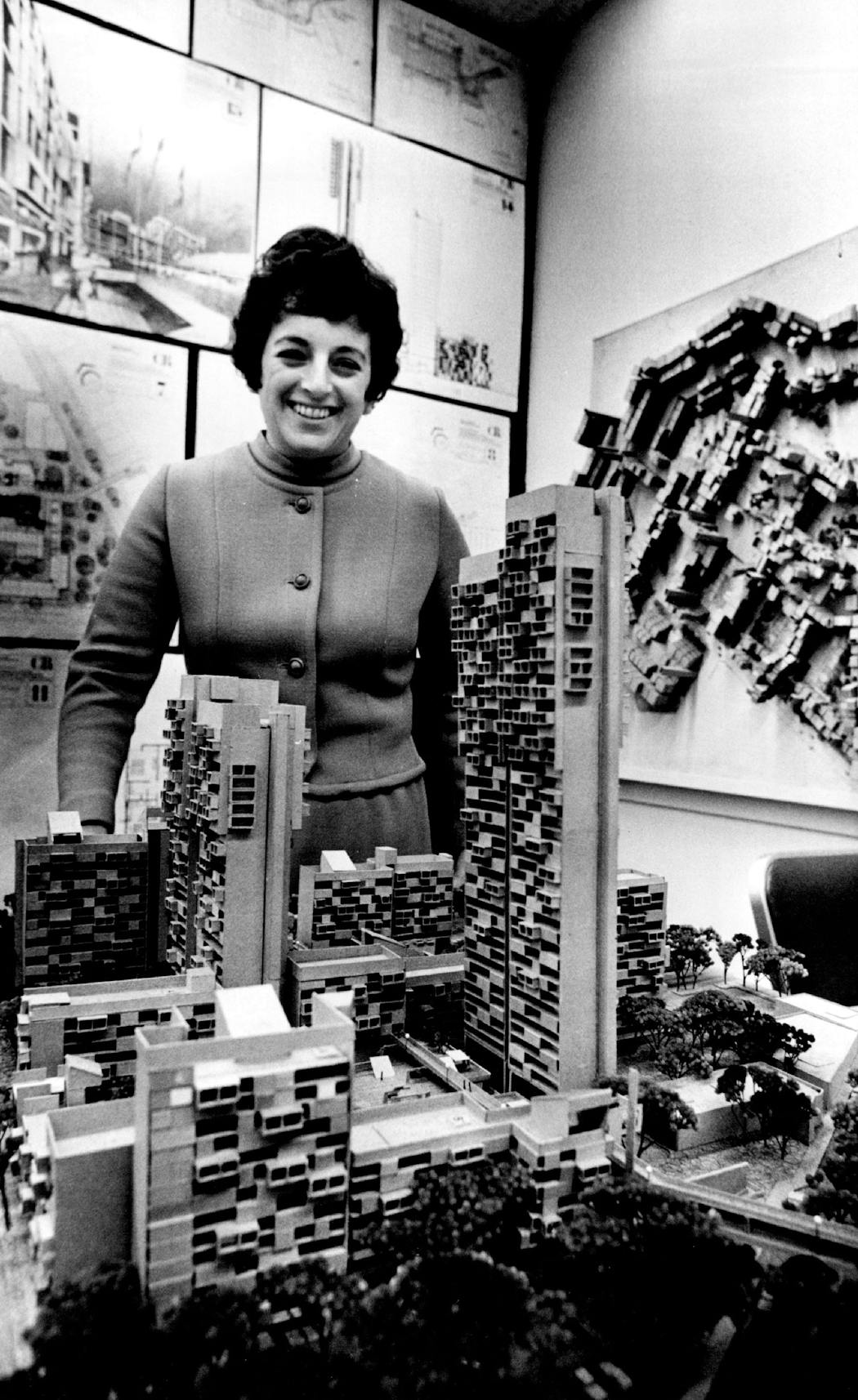 Gloria Segal beside a model of the proposed Cedar-Riverside development in 1970.