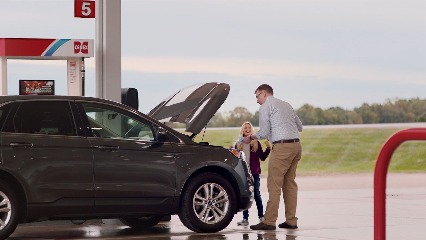 During a 15-second commercial for Cenex that will regionally during the Super Bowl, a father shows his daughter how to change oil.
Courtesy Colle McVoy