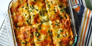 Creamy Green Chicken and Roasted Corn Enchilada Casserole is a cheesy variation on a favorite childhood dish.