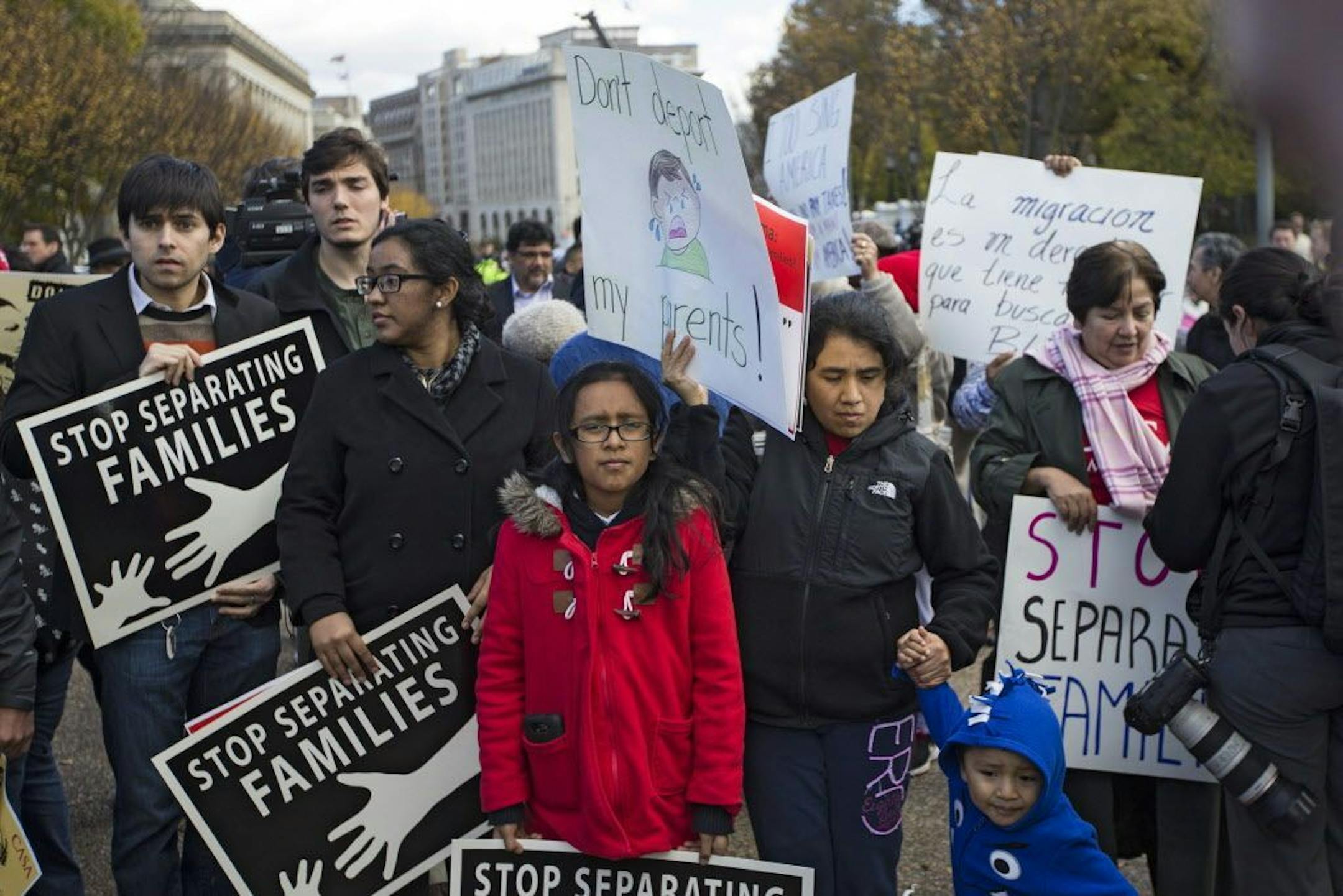 FILE -- Demonstrators gather near the White House, urging administrative action on immigration, in Washington, Nov. 7, 2014.