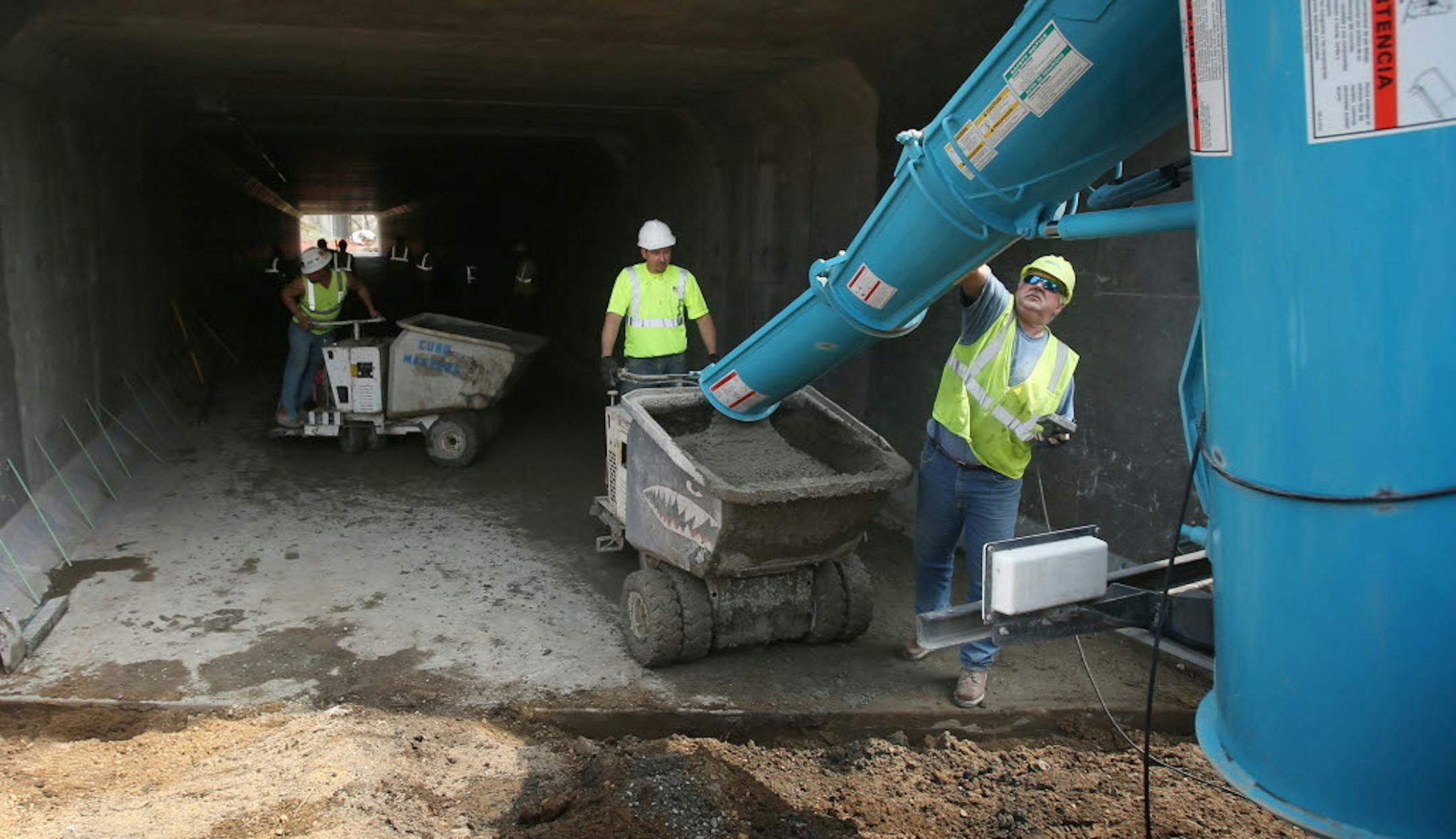May 7, 2014: A Minneapolis inspector (left) looked on as workers poured concrete for the bike trail under 35W in Minneapolis.