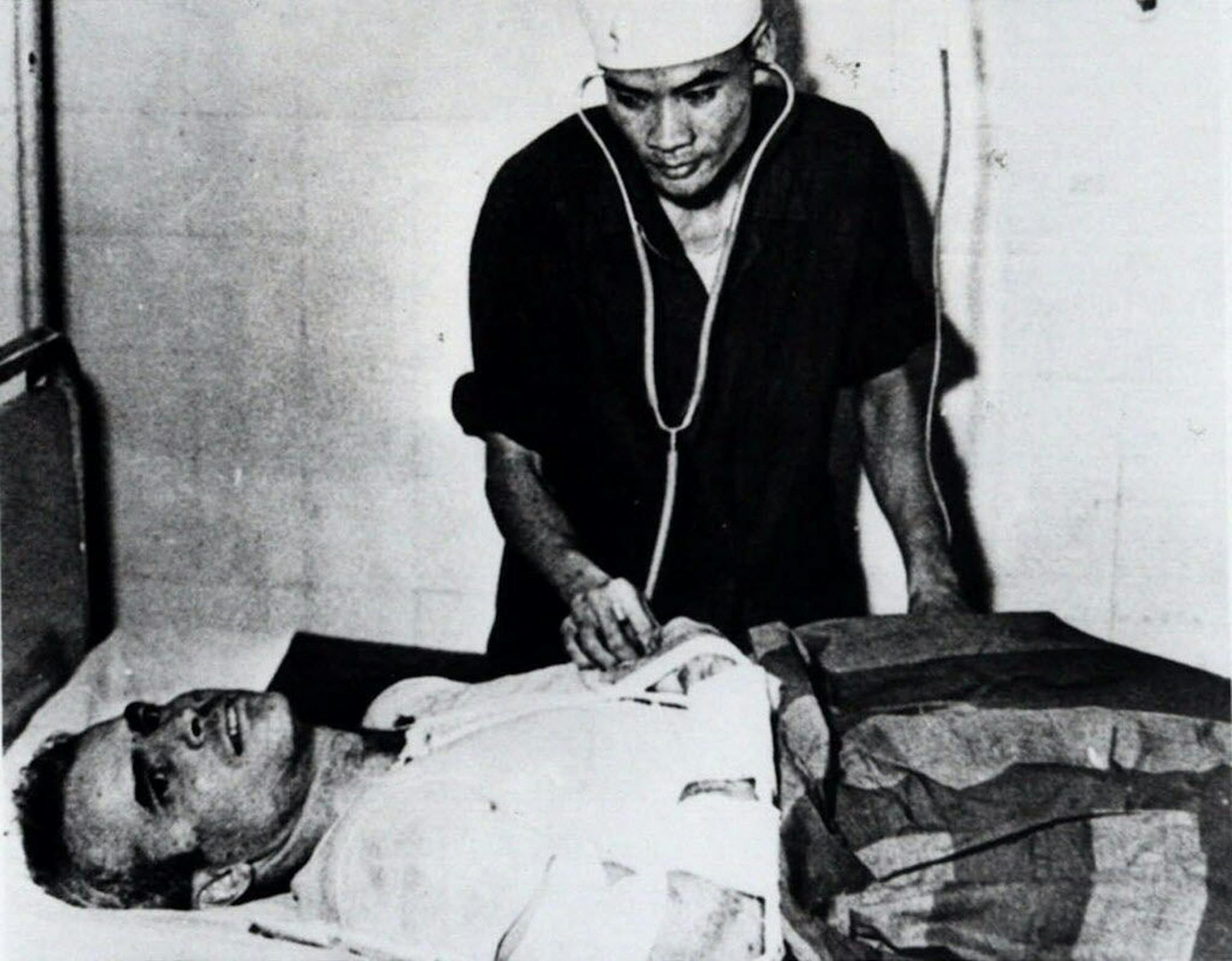 FILE - In this fall 1967 file photo, John McCain is administered to at a Hanoi, Vietnam hospital as a prisoner of war.